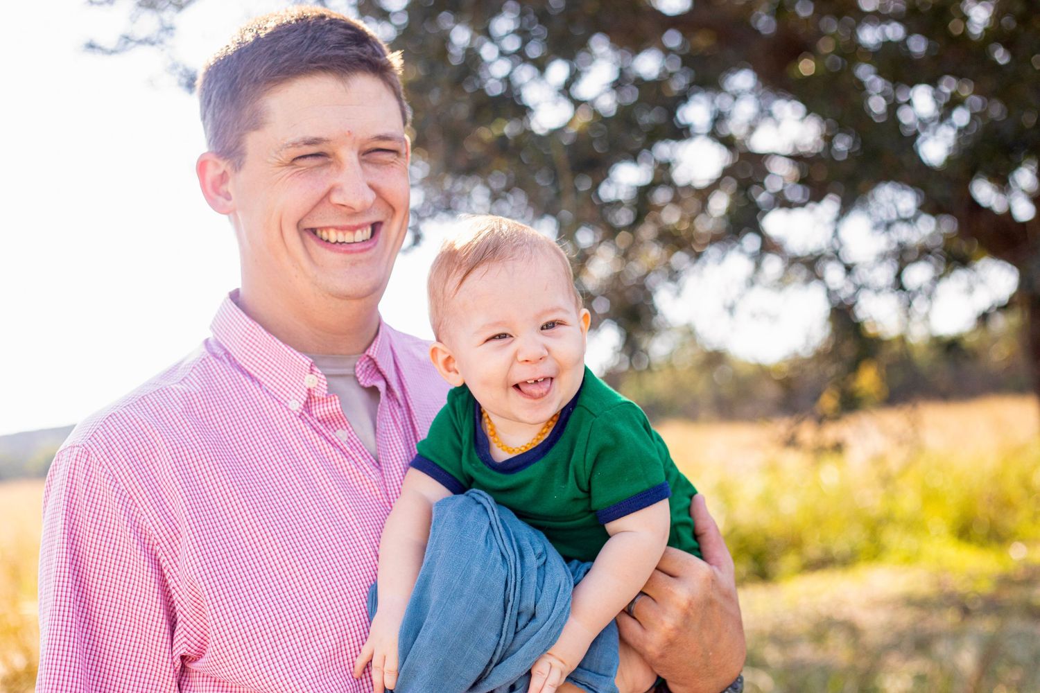 A heartwarming family moment captured in a sunny field.