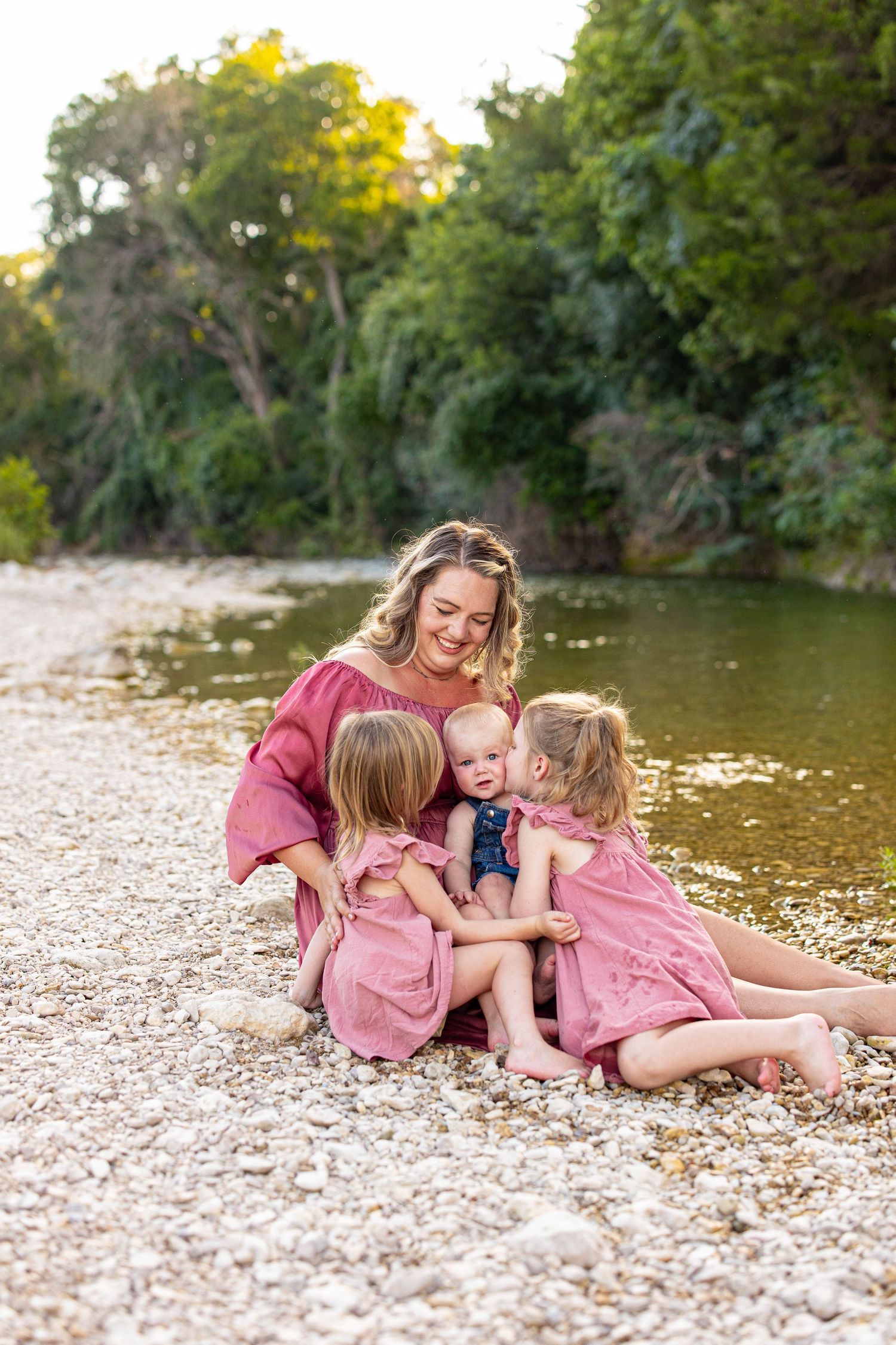 Joyful family moments shared on a sunny day by the water's edge.