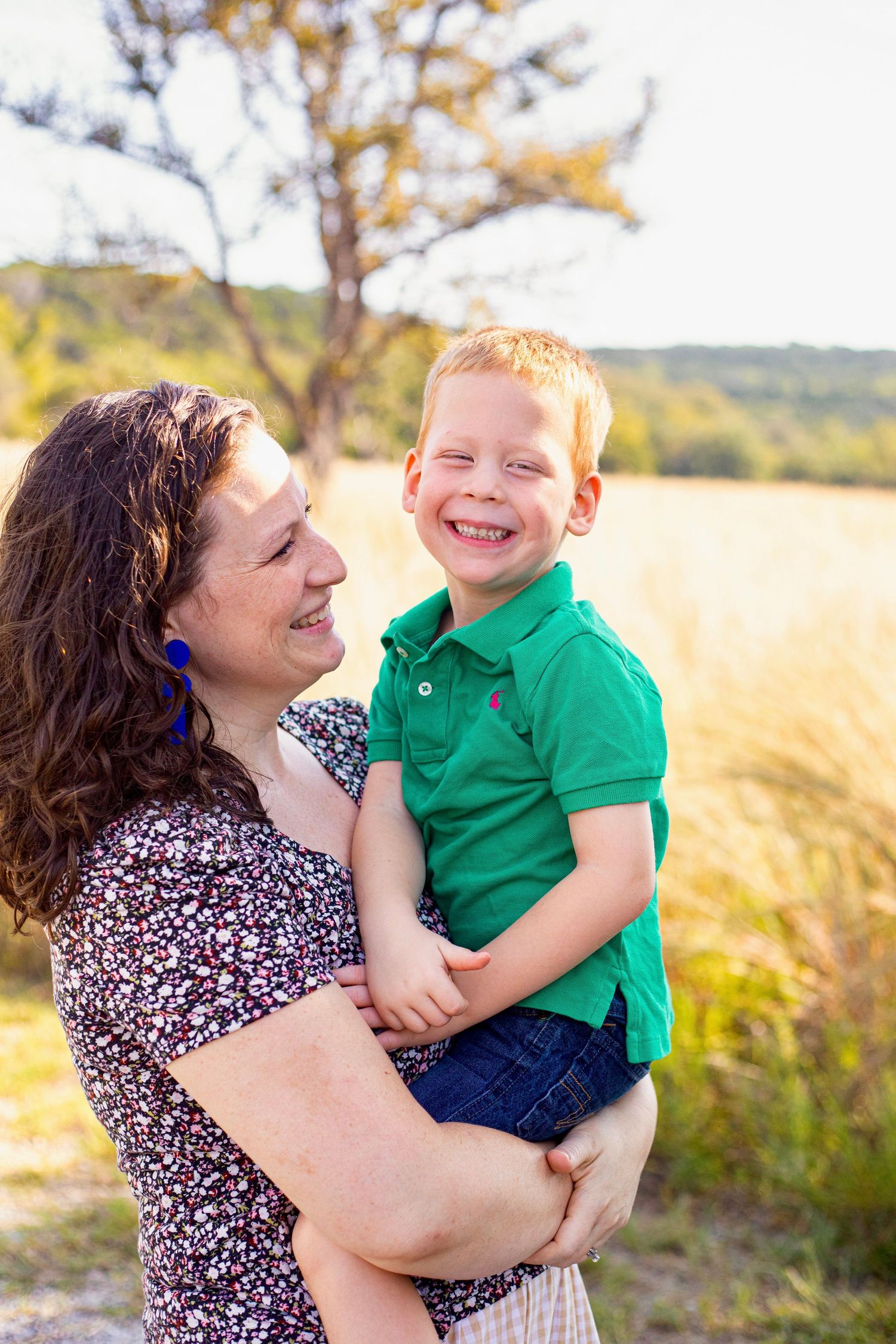 Joyful playtime in a golden field with tall grass and natural sunlight during golden hour.