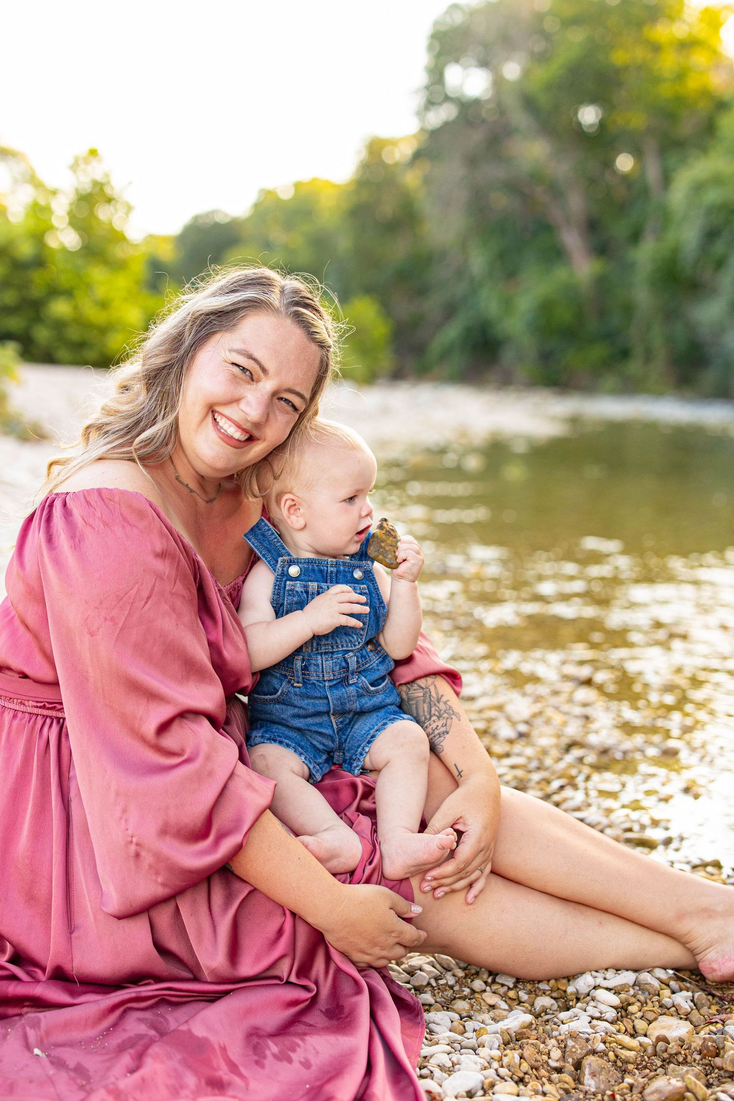 A joyful summer moment captured by the riverside with matching pink and denim outfits.