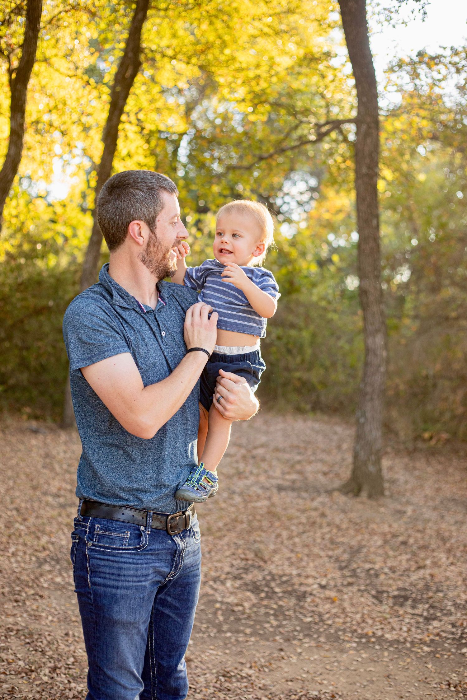 Sweet bonding moment in a golden autumn forest setting.