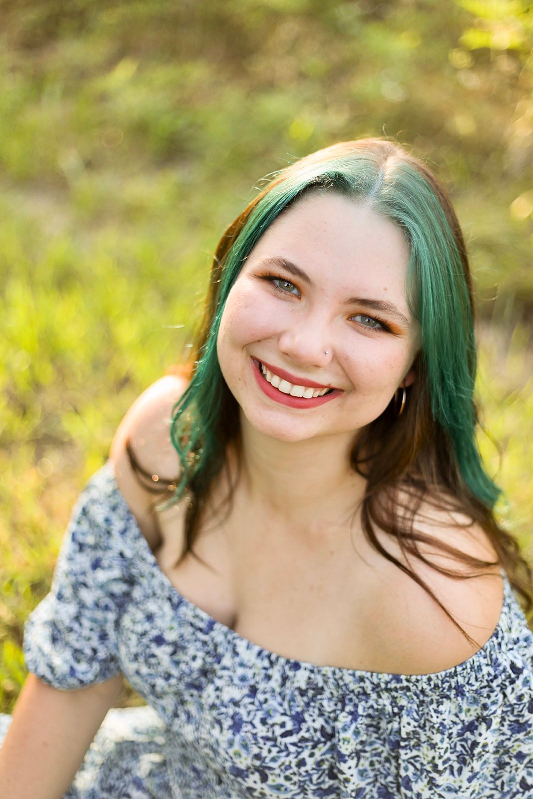 Candid outdoor portrait series with floral dress against natural background.
