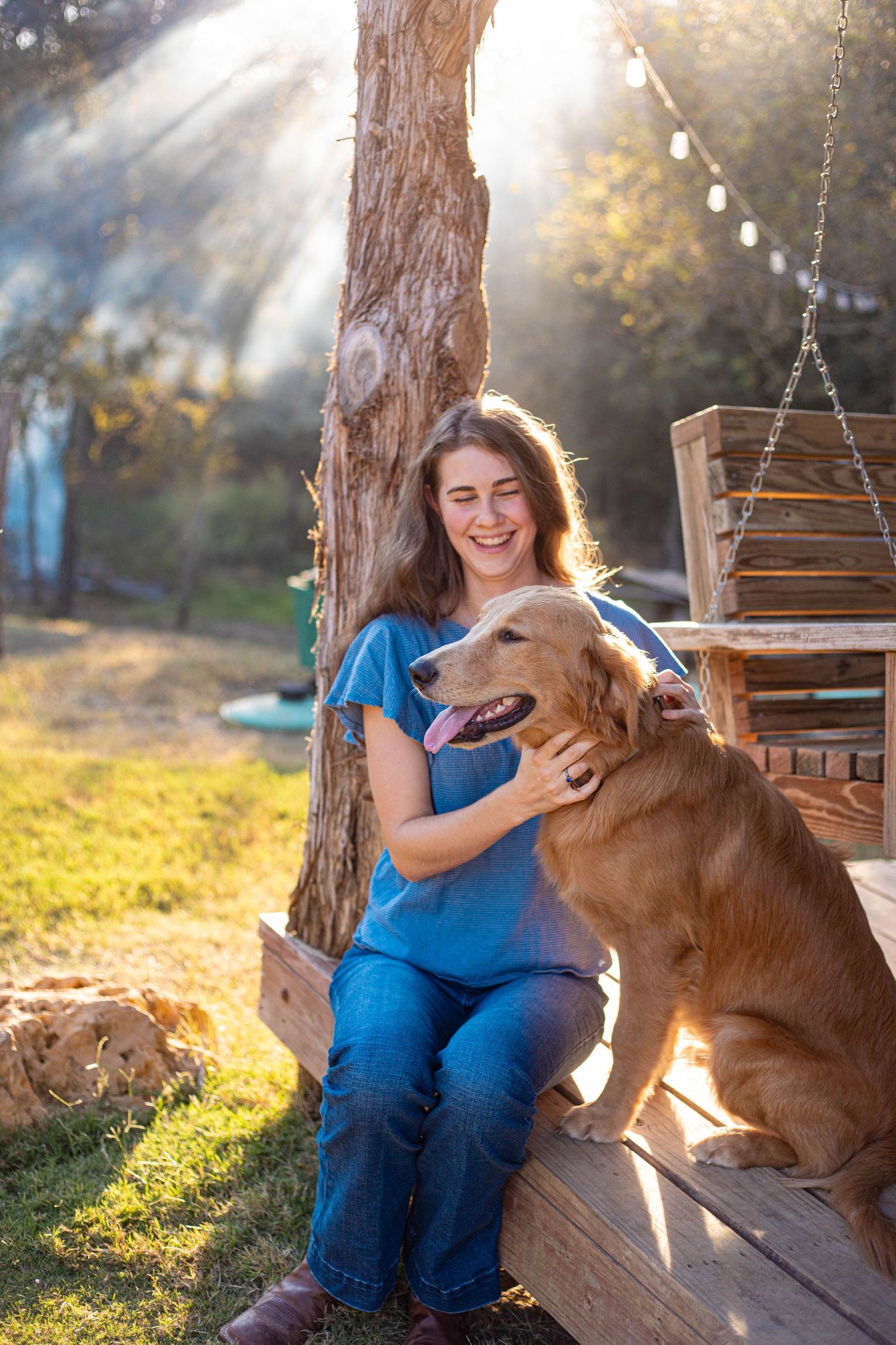 Golden retriever and person sharing a joyful moment on rustic wooden deck.
