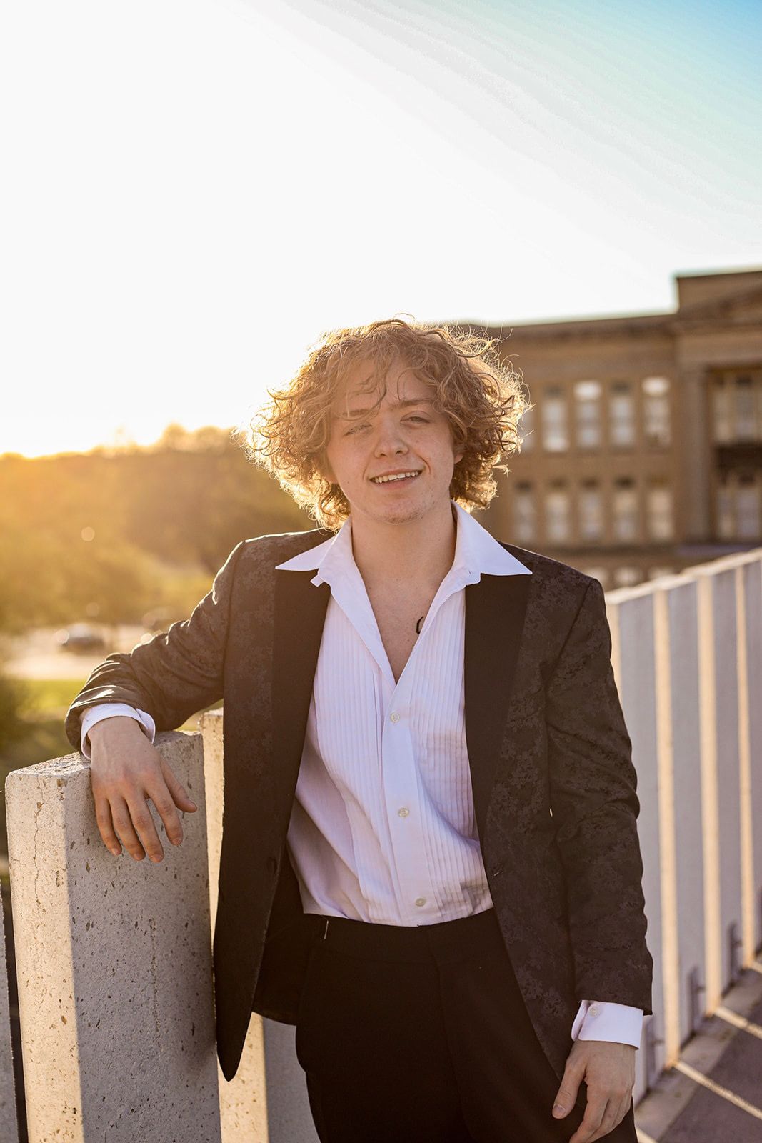 Professional portrait series at sunset wearing formal black suit.