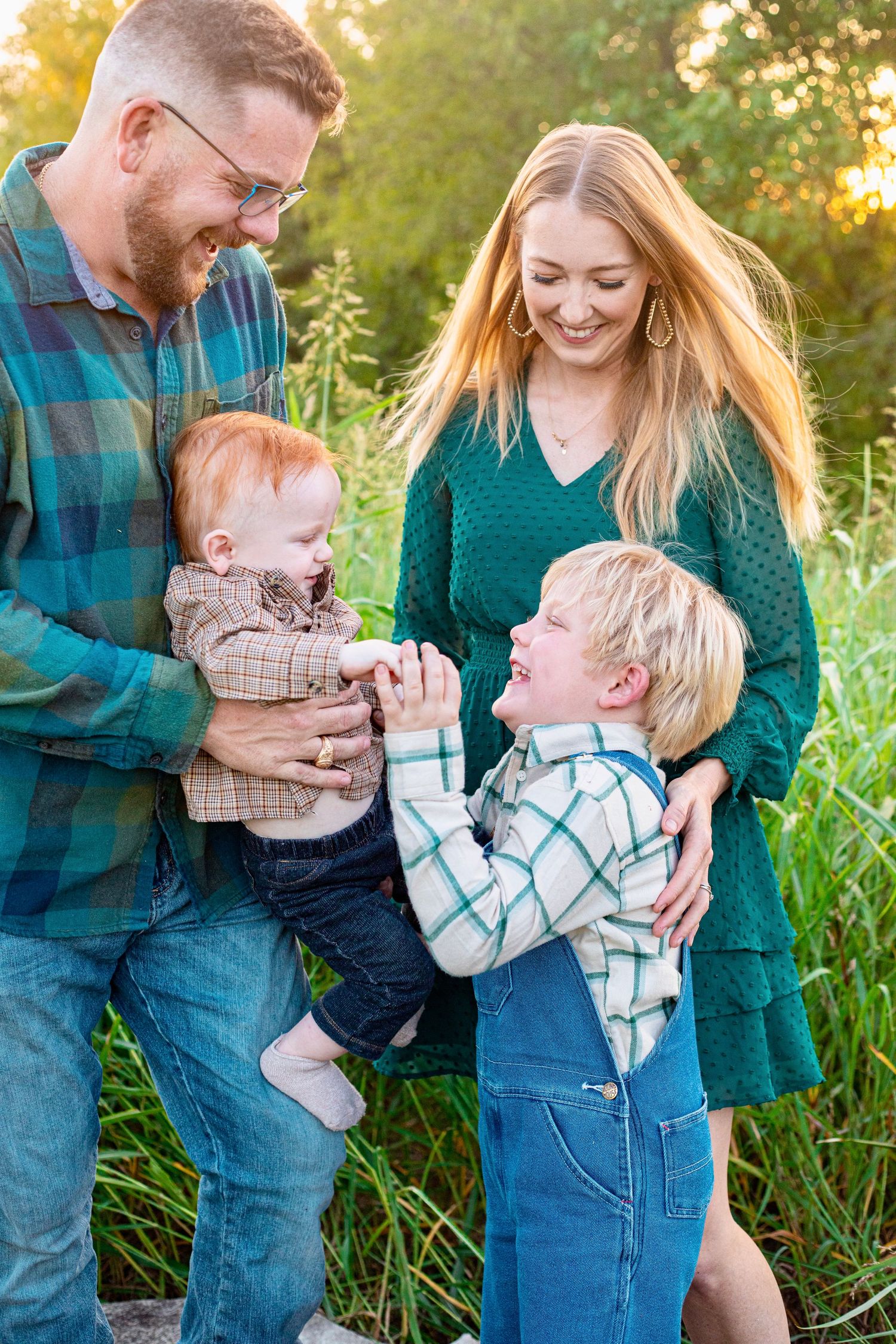A family shares a playful moment together outdoors during golden hour.