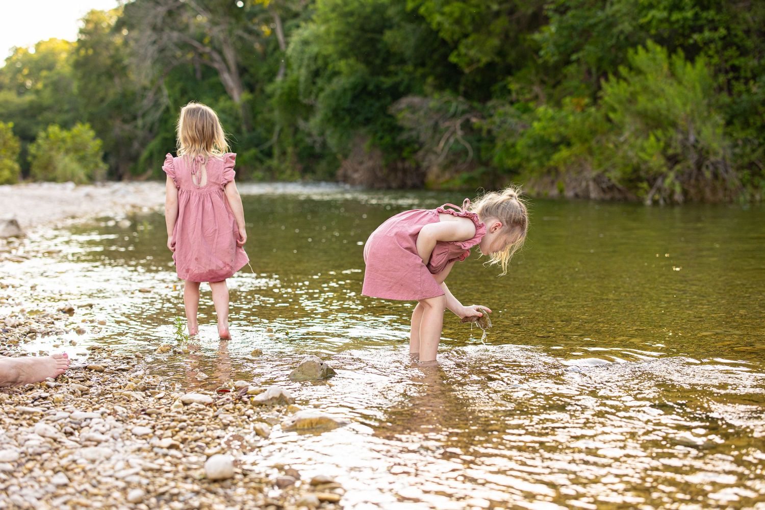 Playful afternoon spent wading in gentle river waters during golden hour.