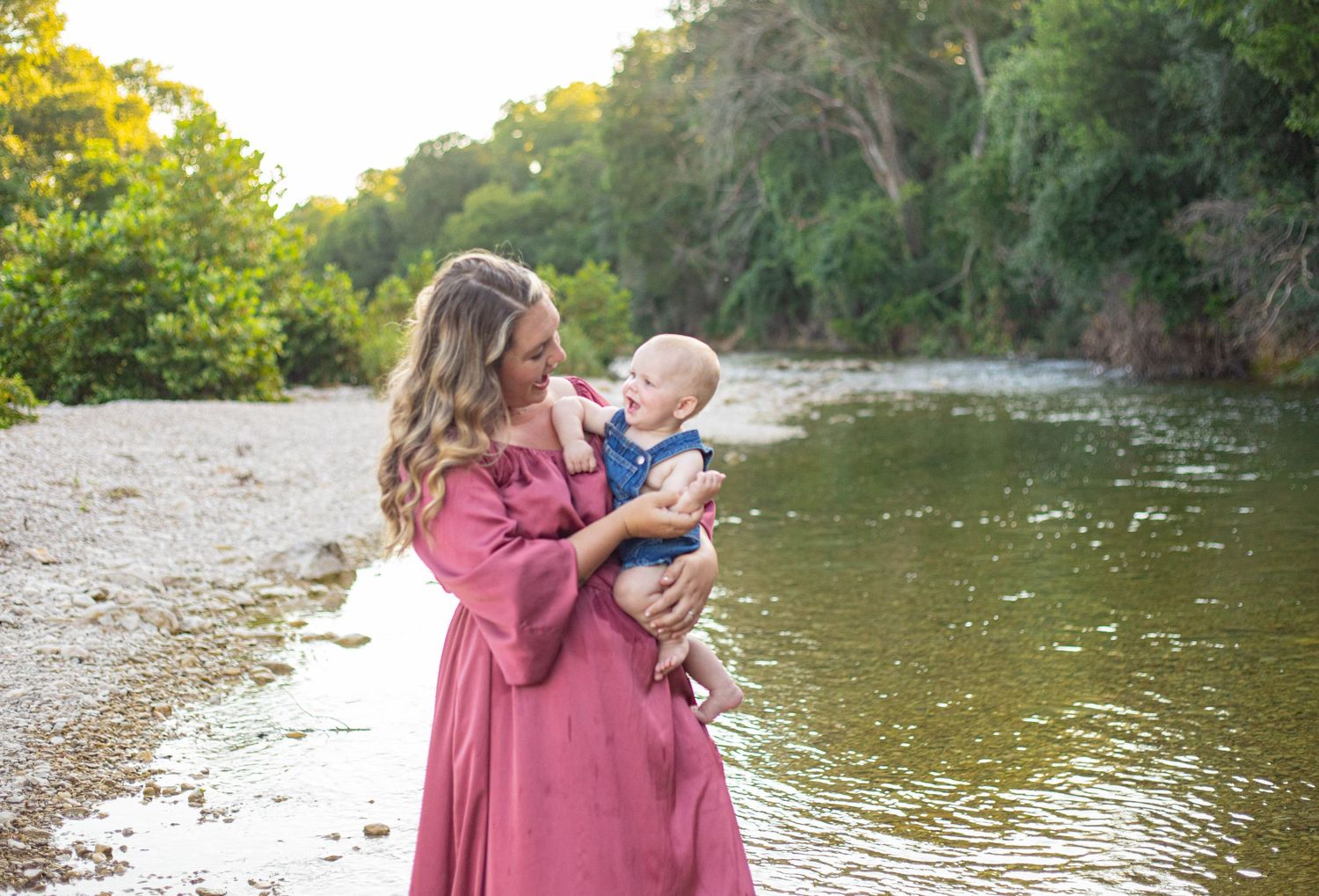 A tender moment captured by the water's edge during golden hour.