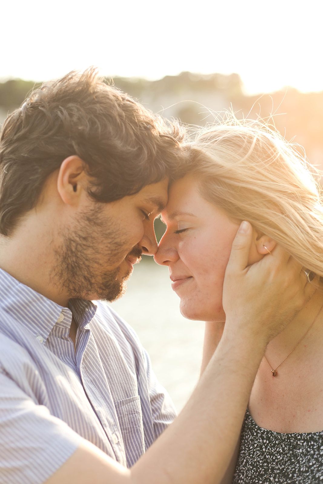 Close-up of tender moment between couple during golden hour photography session.