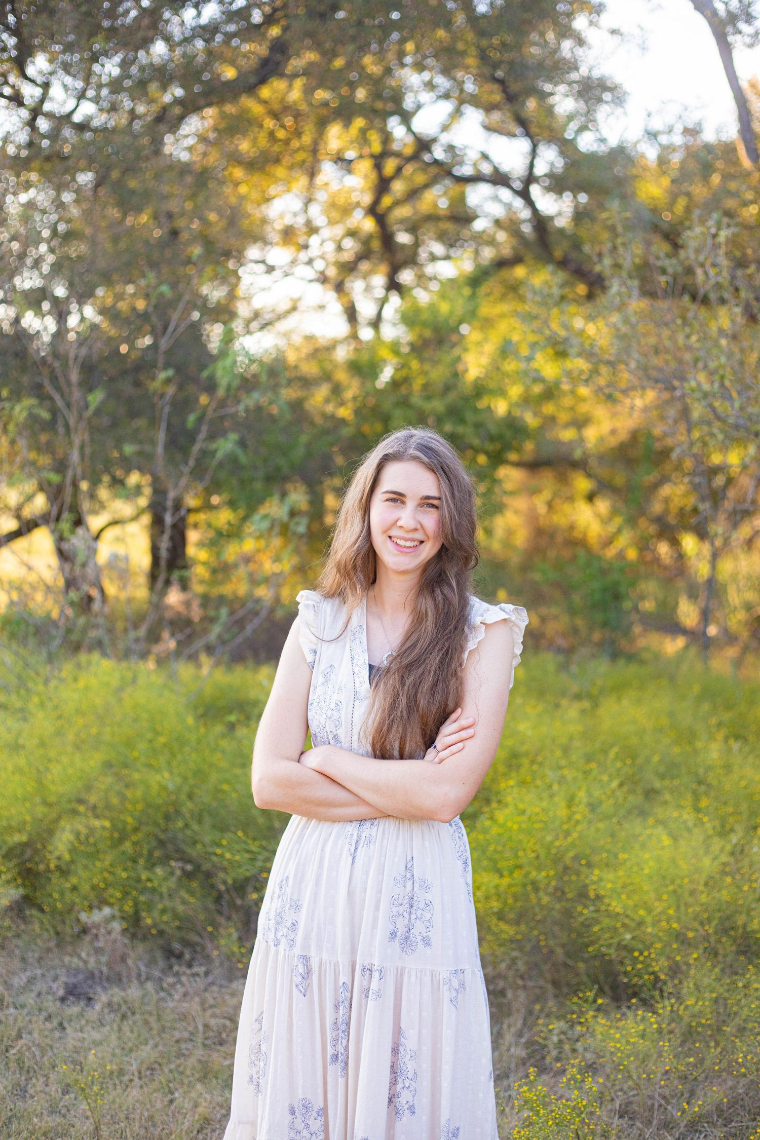 White floral dress portrait with joyful expressions in outdoor nature setting.