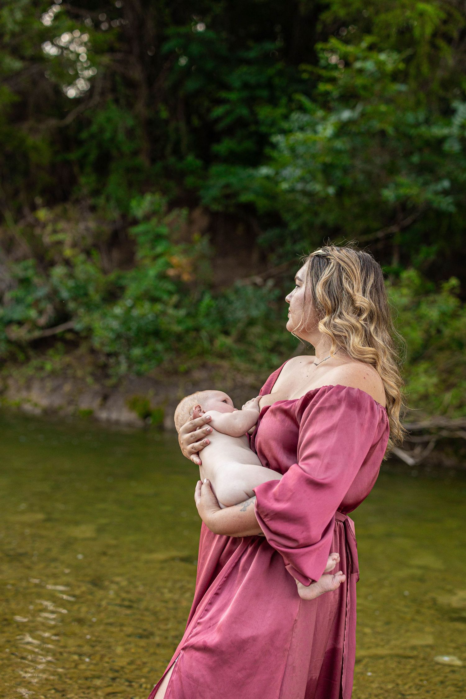 Natural outdoor portraits in a mauve dress by the riverside.