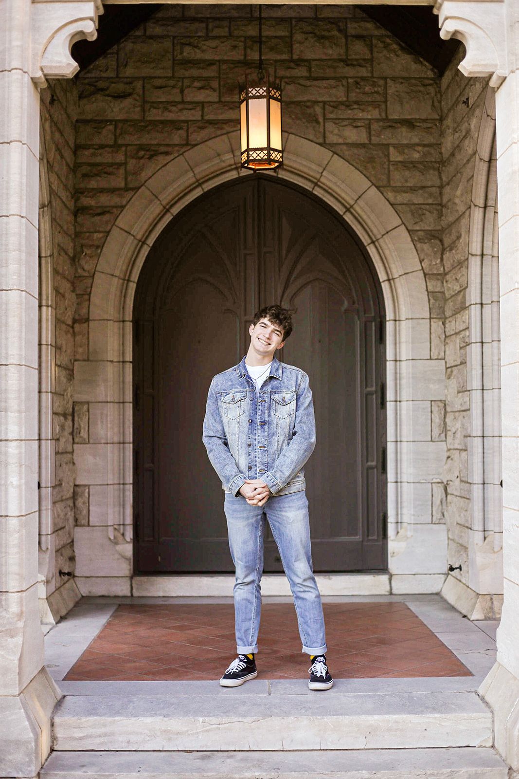 Fashion poses showcasing denim style within stone archways of classical architecture.