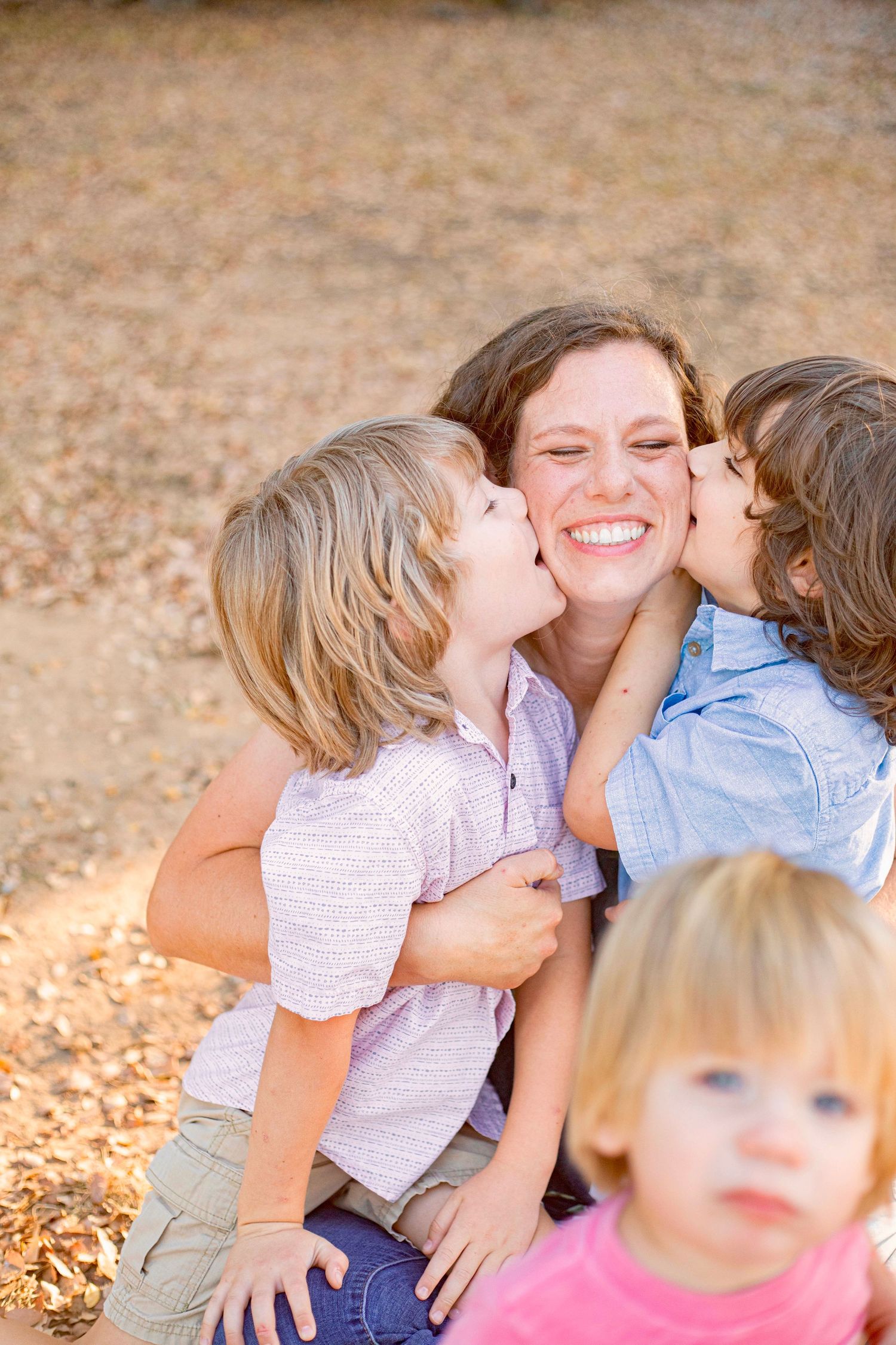 Tender family moment captured on fallen autumn leaves.