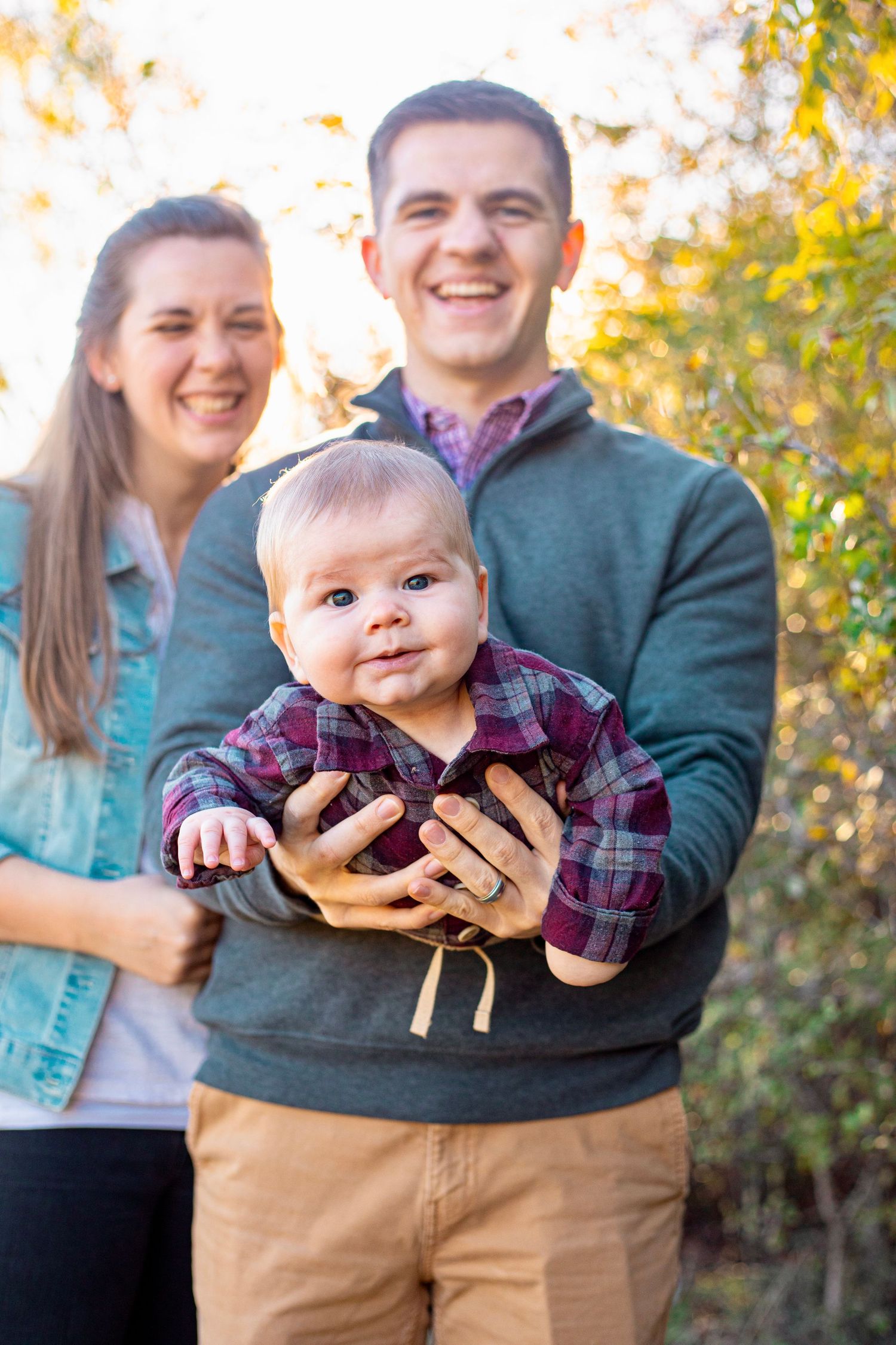 Candid family portraits in casual attire against autumn foliage background.