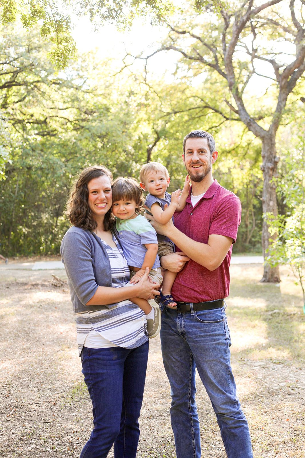 Casual family portraits in a wooded park setting during golden hour.
