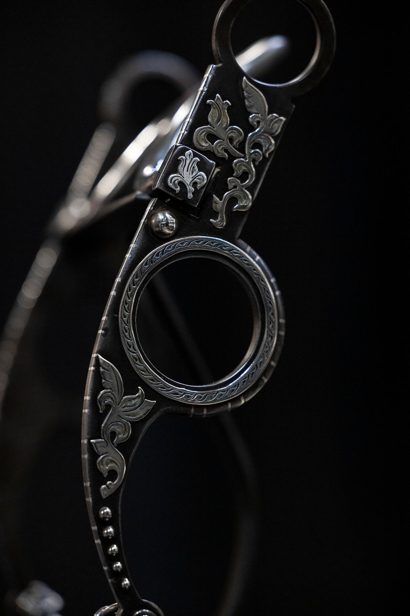 Handmade bit displayed on dark background.