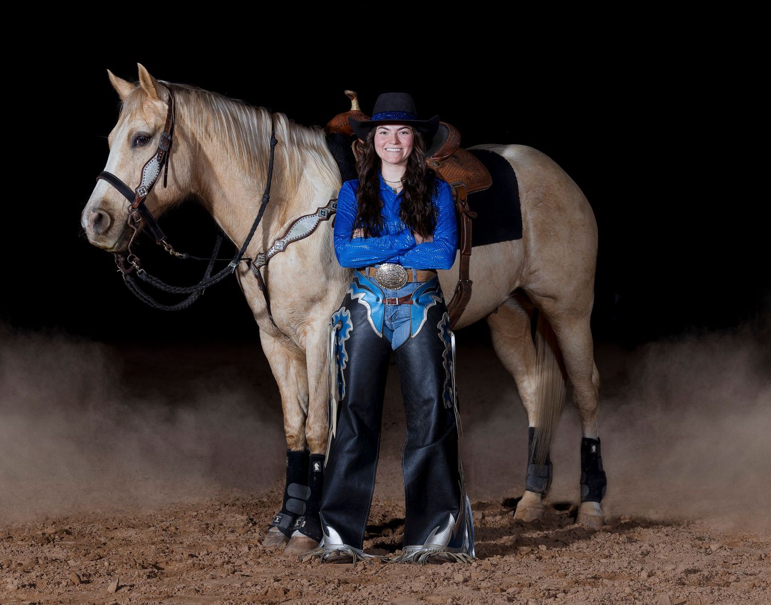 Black background portrait dusty arena at night using off camera strobes.