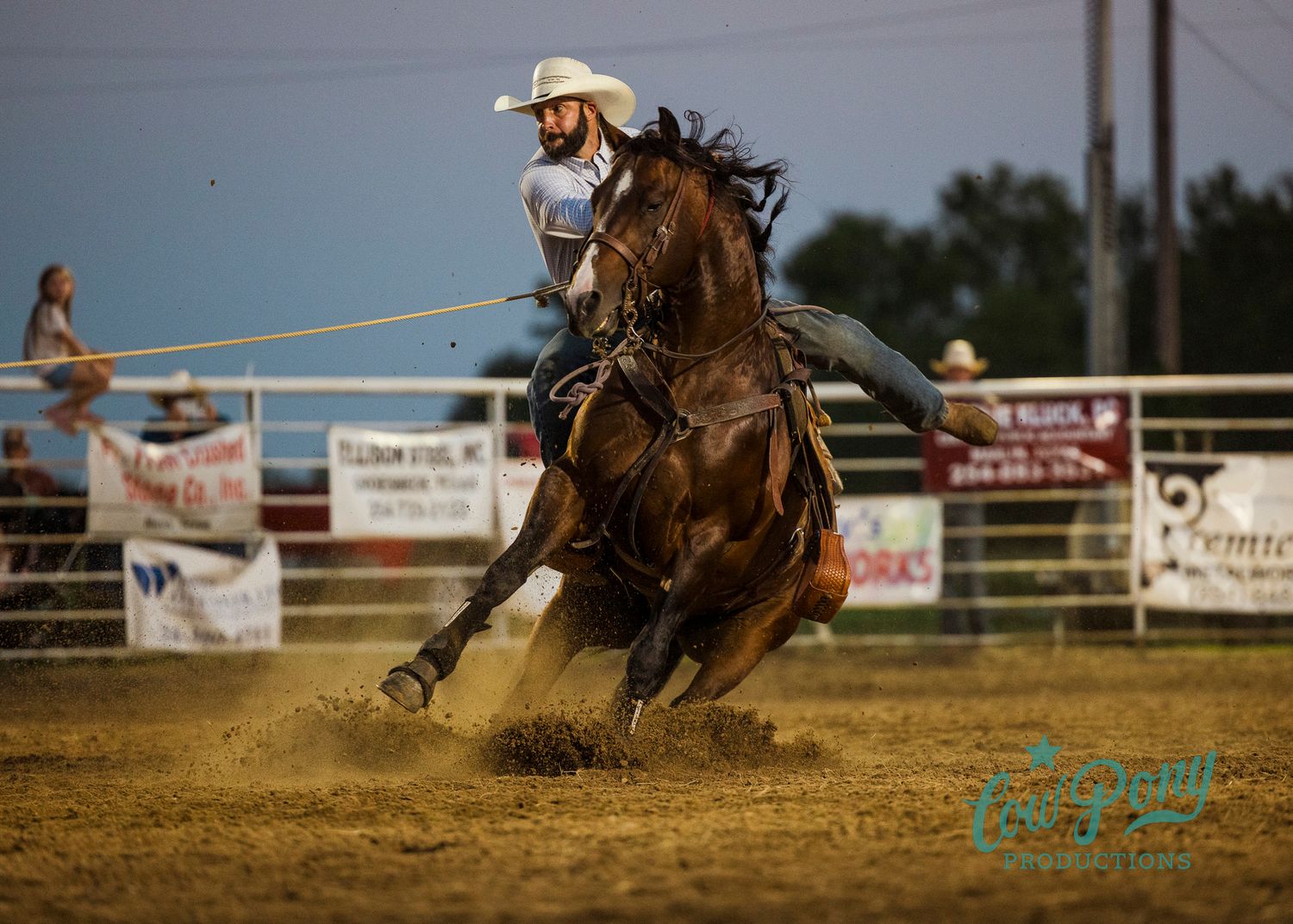 A calf roper and horse kick up dust at the Thornton homecoming rodeo