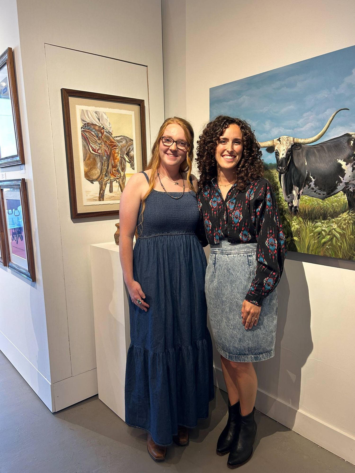 2 people dressed in their best western attire at an art gallery in Waco, Texas