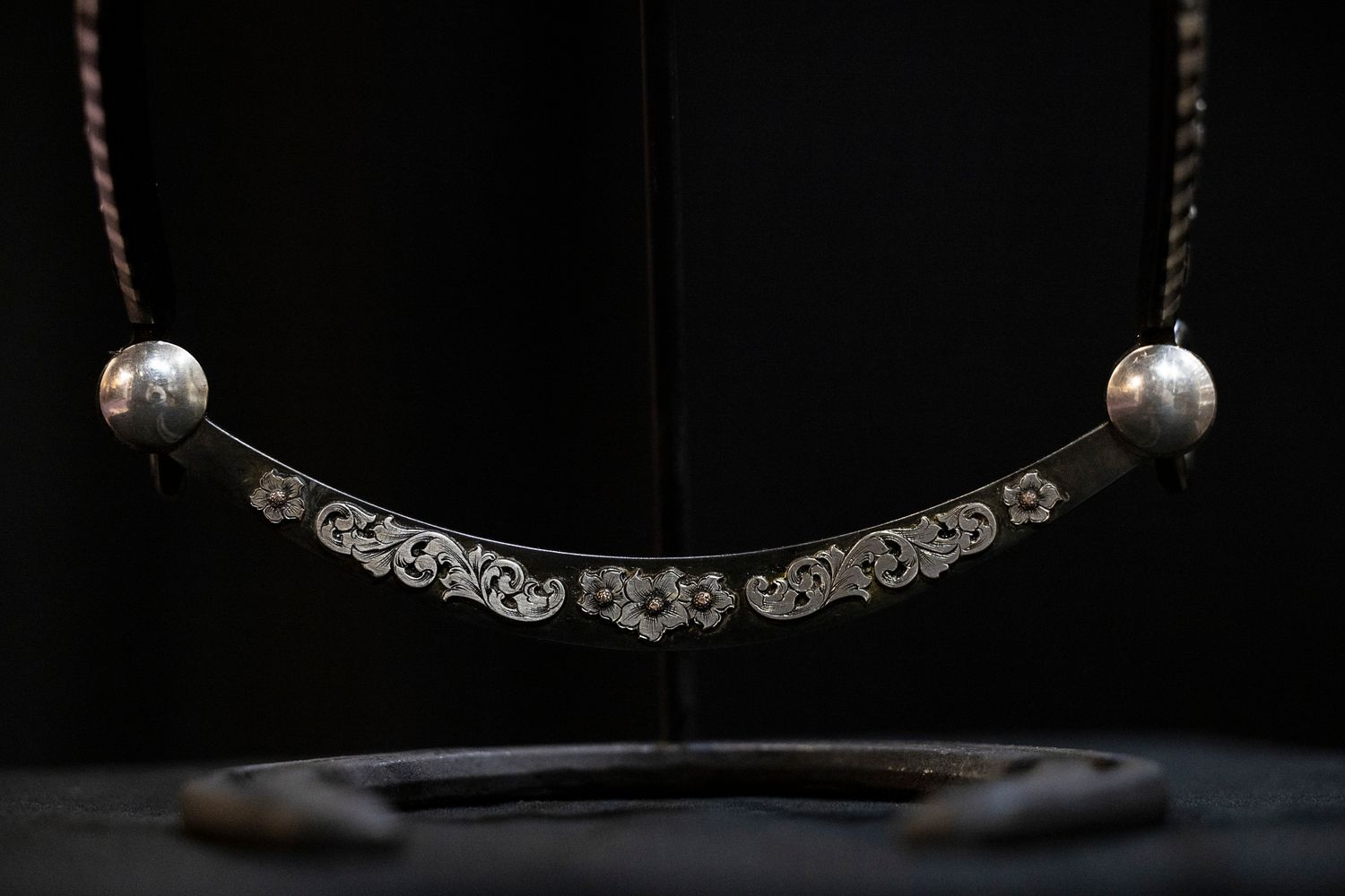 Handmade bit displayed on dark background.