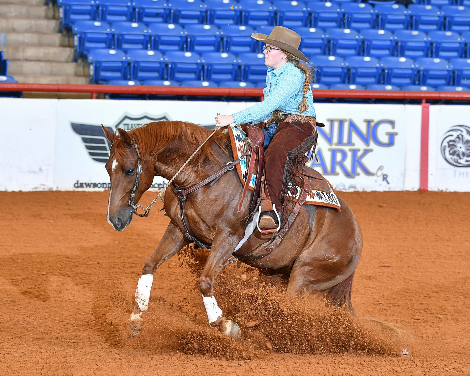 A Smart Carebear doing a sliding stop on the John Justin Arena. Photo by High Cotton Promotions