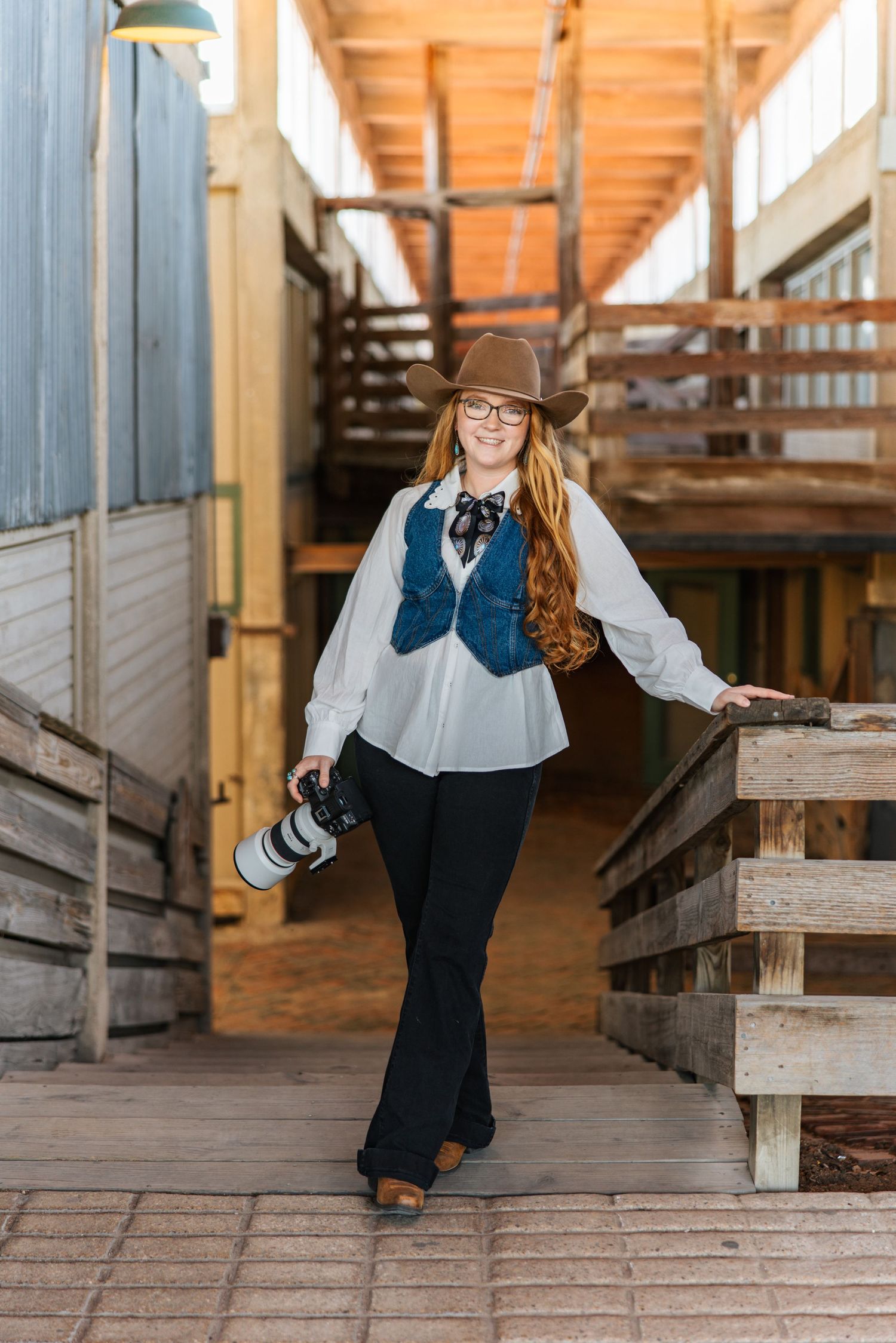 a cowgirl photographer standing in the Fort Worth Stockyards