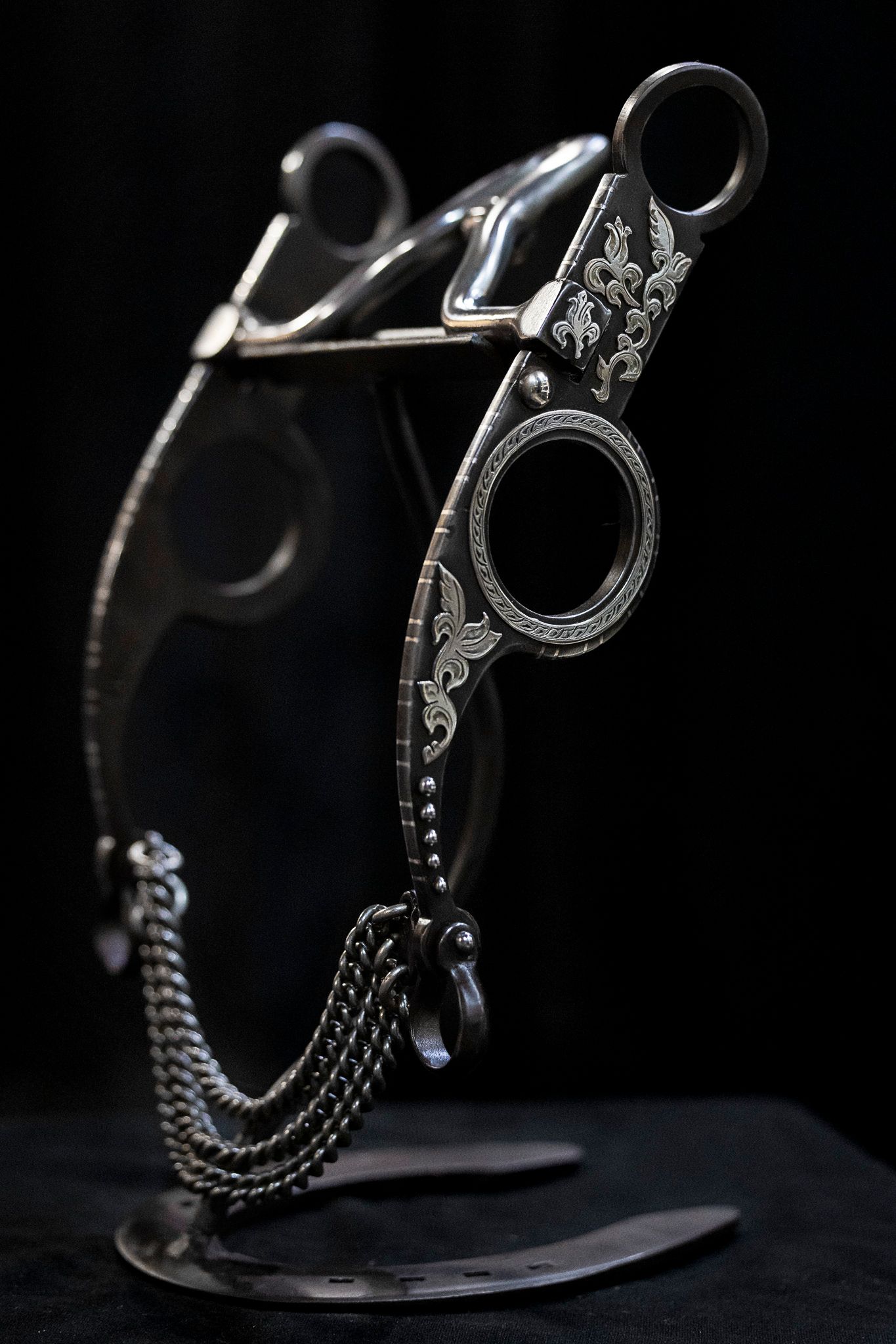 Handmade bit displayed on dark background.