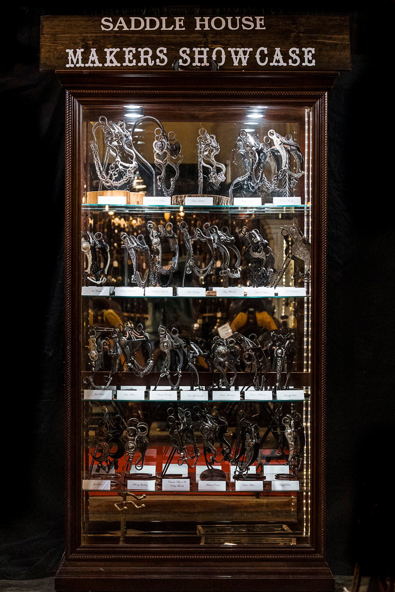 Saddle House Bit Makers Showcase cabinet holding lots of intricate handmade bits