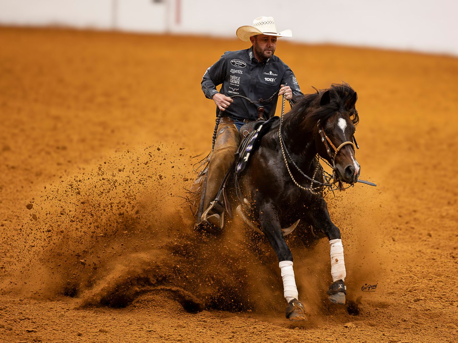 Justin Wright making a sliding stop in the Open Two-Rein at the Wild Rag