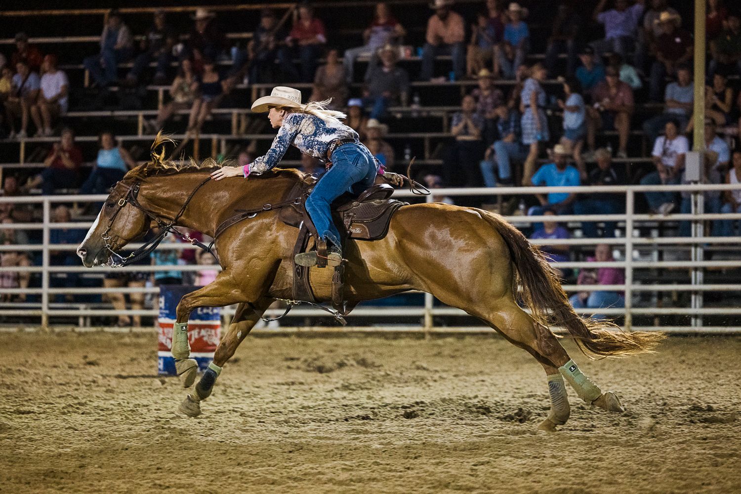 A Barrel Racer and sorrel horse running home with a long stride at the Teague 4th Of July Rodeo