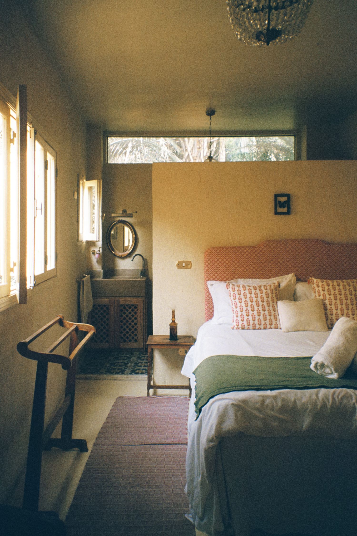 Interior of a hotel bedroom in Egypt, showcasing a comfortable bed and a table for guests. Analog photography