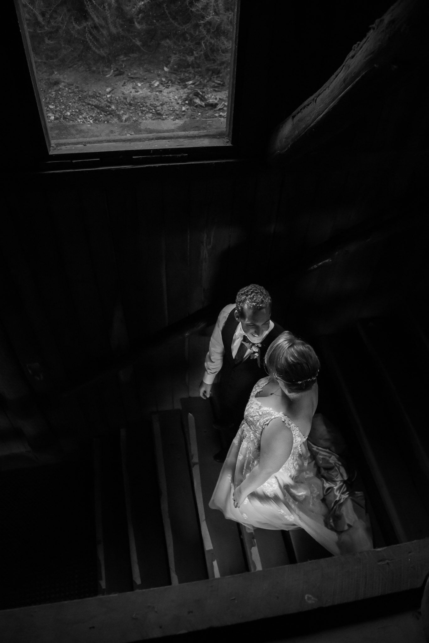 Black and white vintage photographs show a couple sharing intimate moments while seated together in a dark room.
