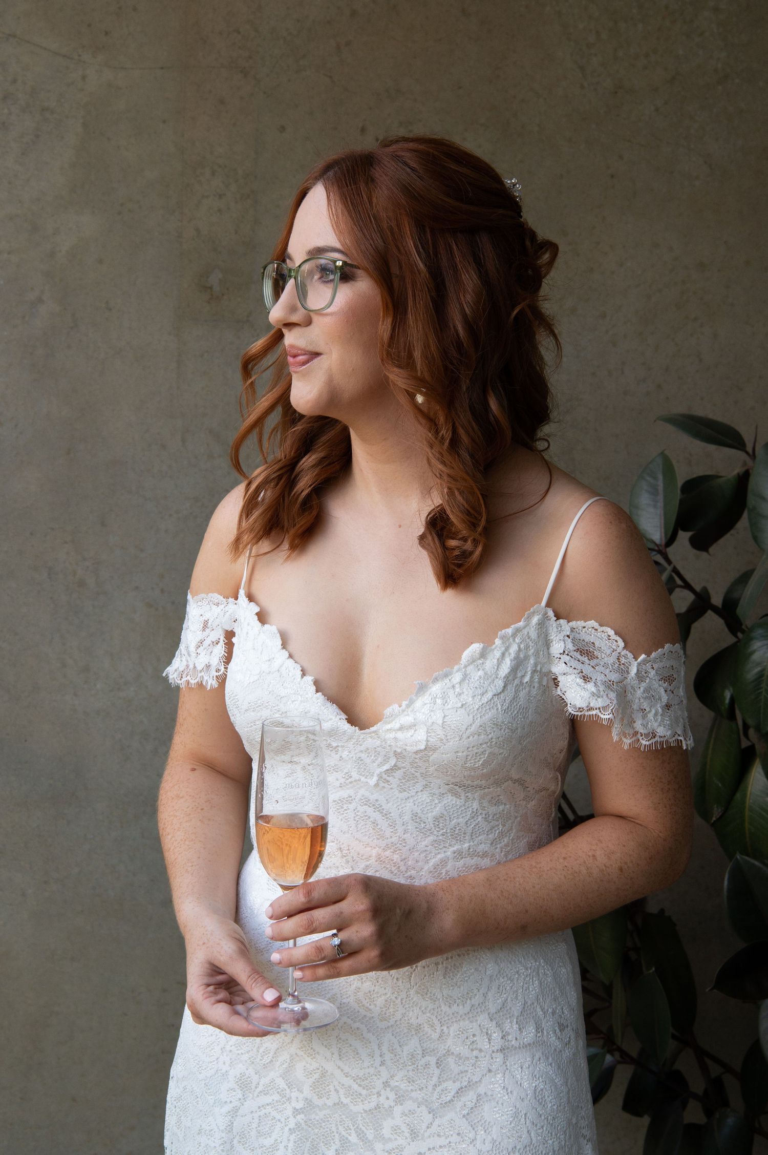 A person wearing a white lace dress holds a beverage in several artistic detail shots.