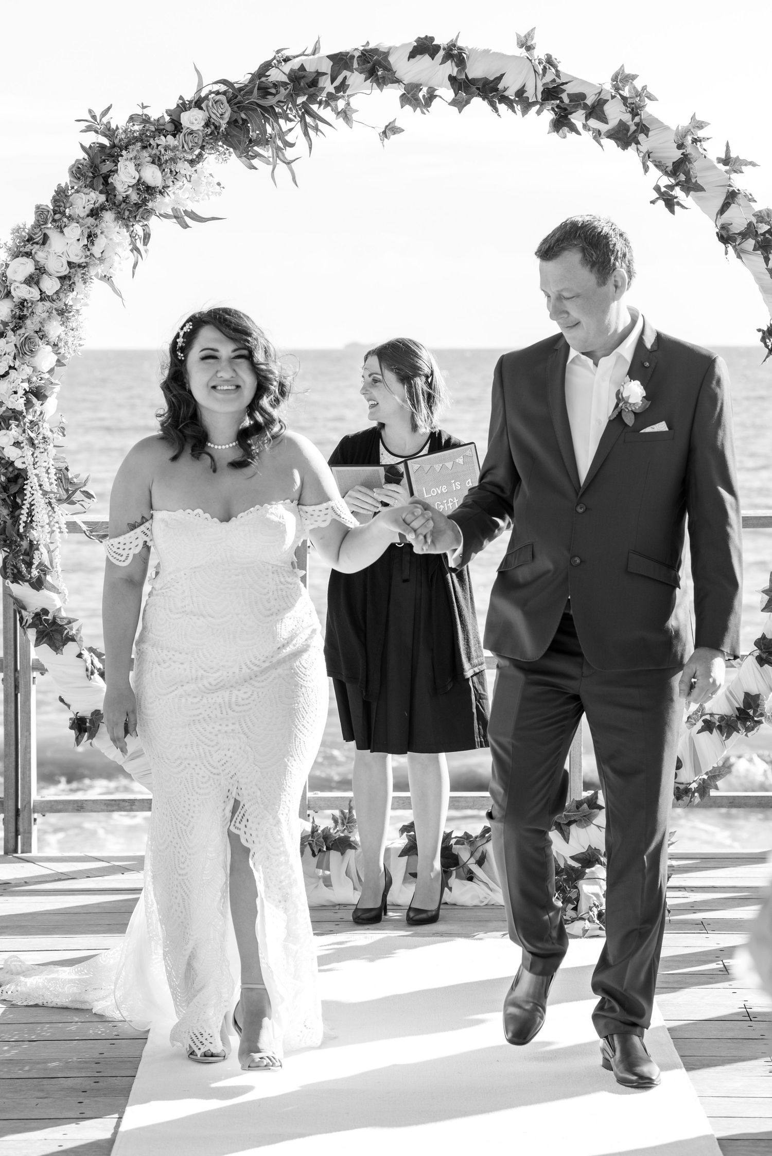 Black and white sequence shows couple walking together outdoors on a sunny day.