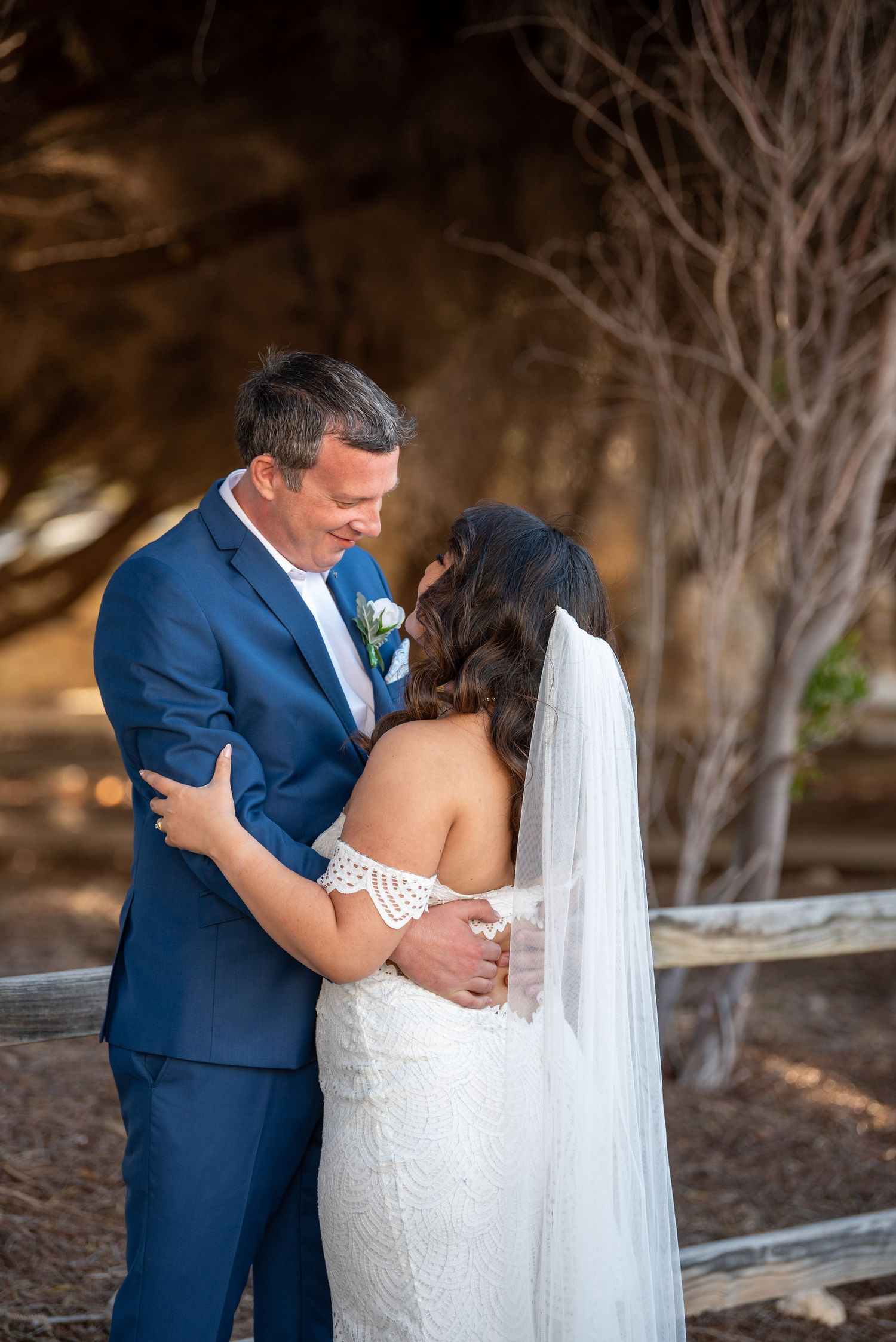 Wedding couple shares intimate moments together during outdoor photo session.