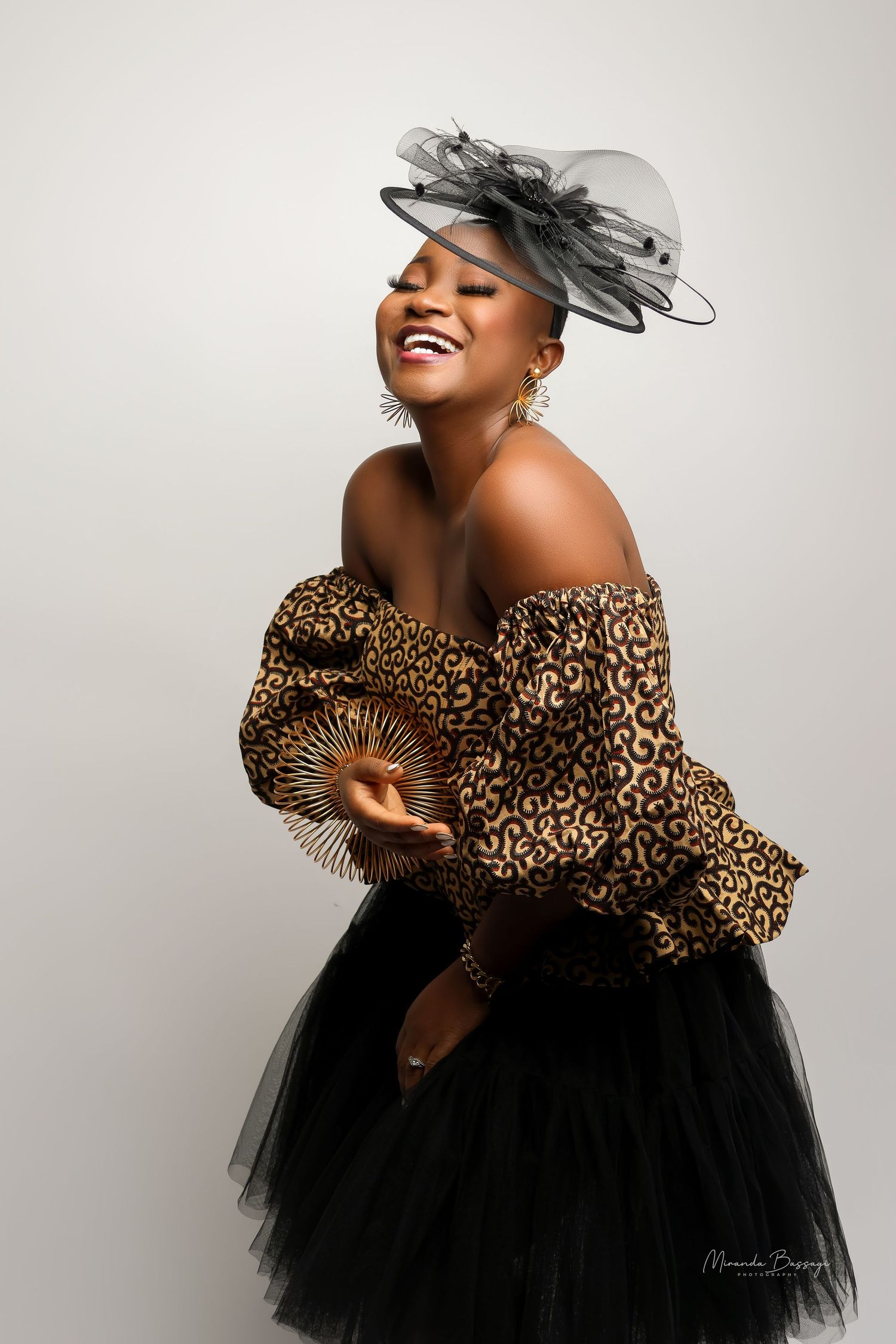 Glamorous fashion portraits featuring leopard print top and black tulle skirt with elegant hat.