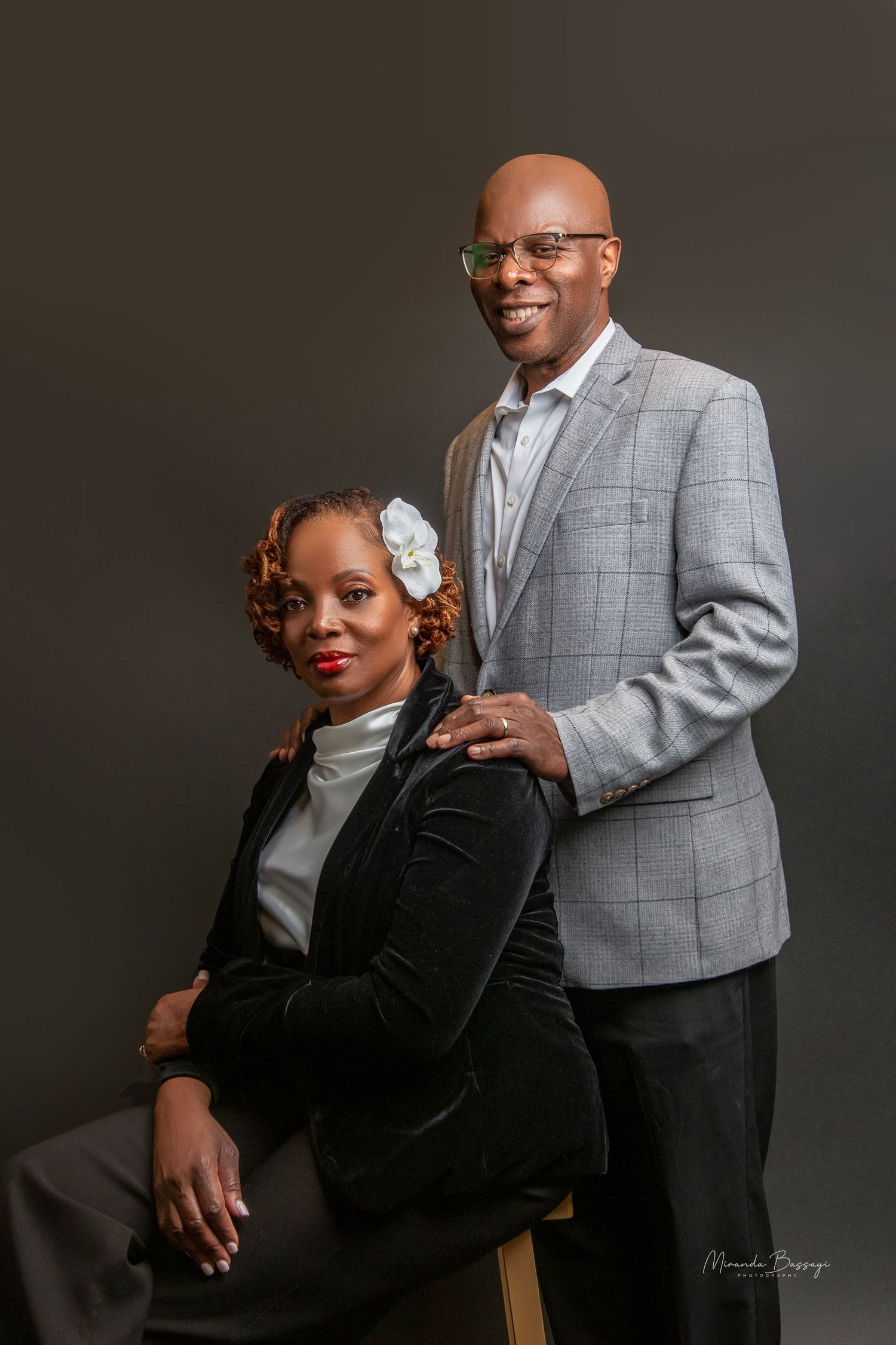 Formal studio portrait with grey plaid blazer and black velvet outfit combination.