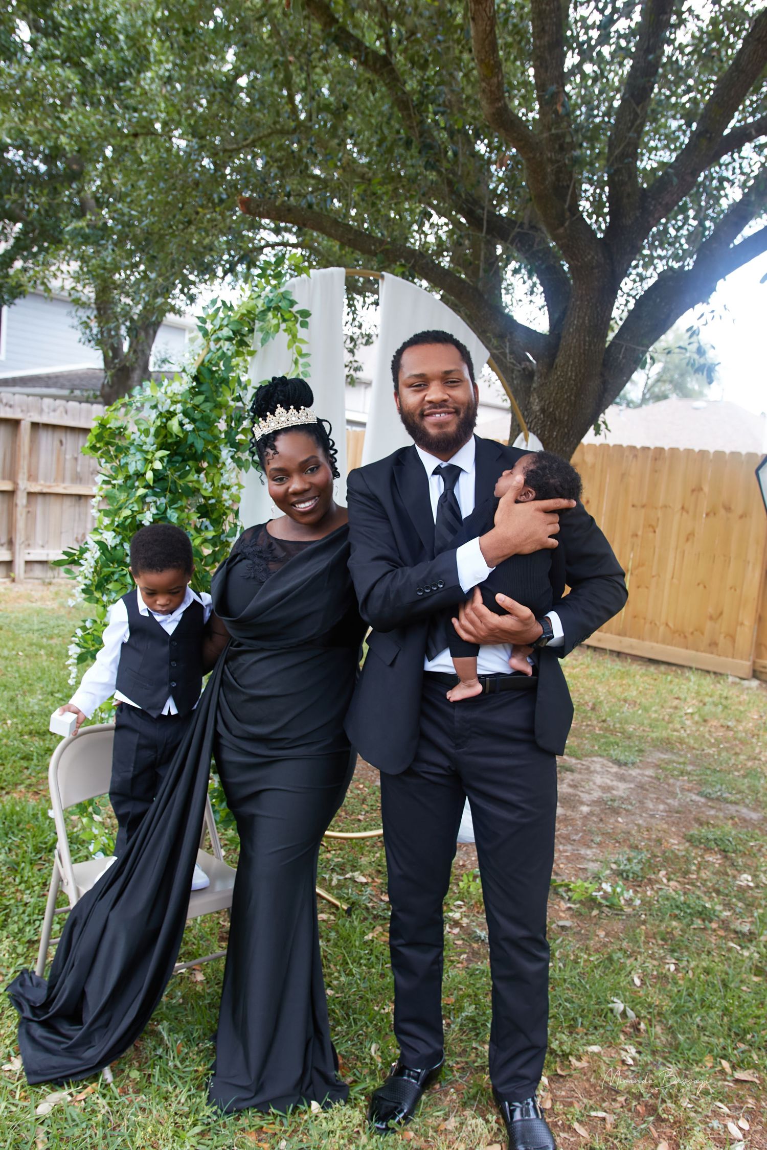 Group photo series showing fun poses in formal black attire under tree.
