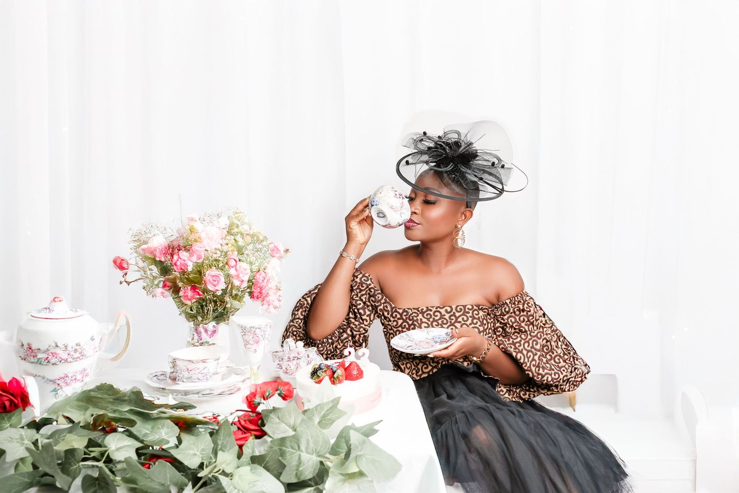 Elegant tea party setting with floral arrangements and feminine fashion styling.