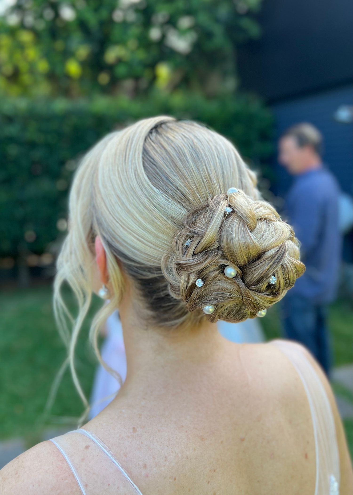 Elegant bridal hairstyle featuring pearl pins and twisted updo shown from various angles.