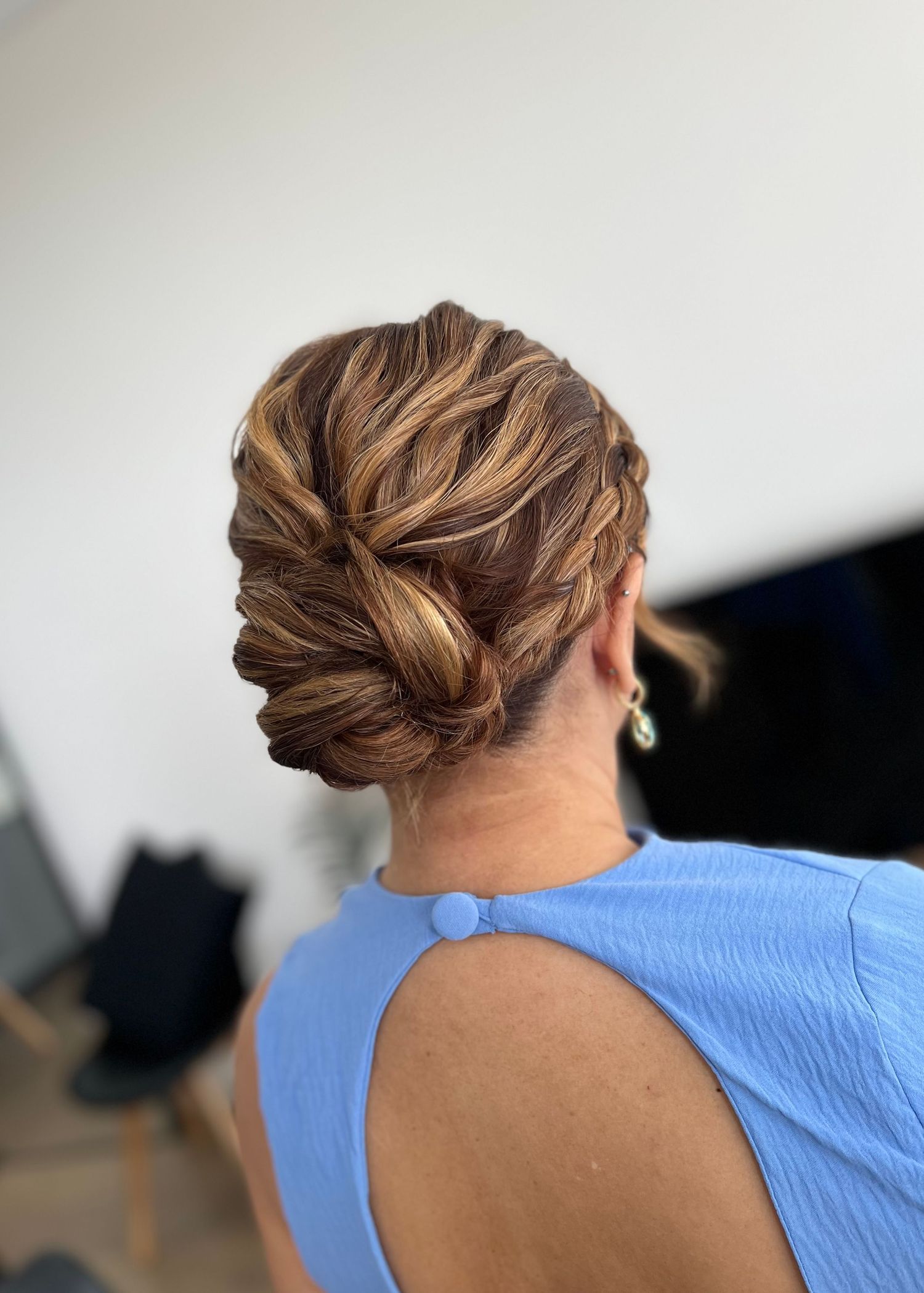 Intricate braided updo hairstyle shown from multiple angles in a blue top.