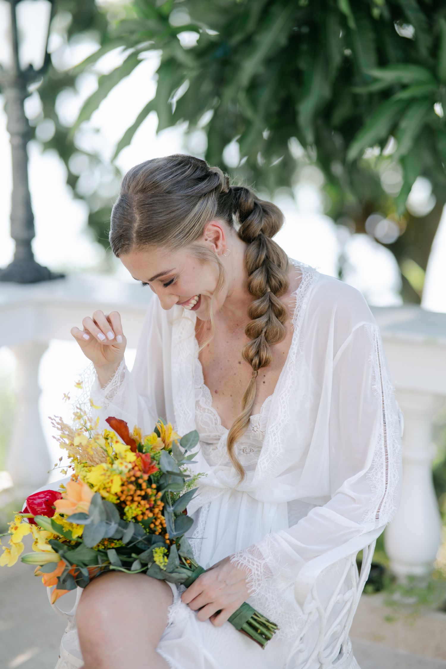 Emotional bridal portraits with colorful wildflower bouquet in natural outdoor setting.