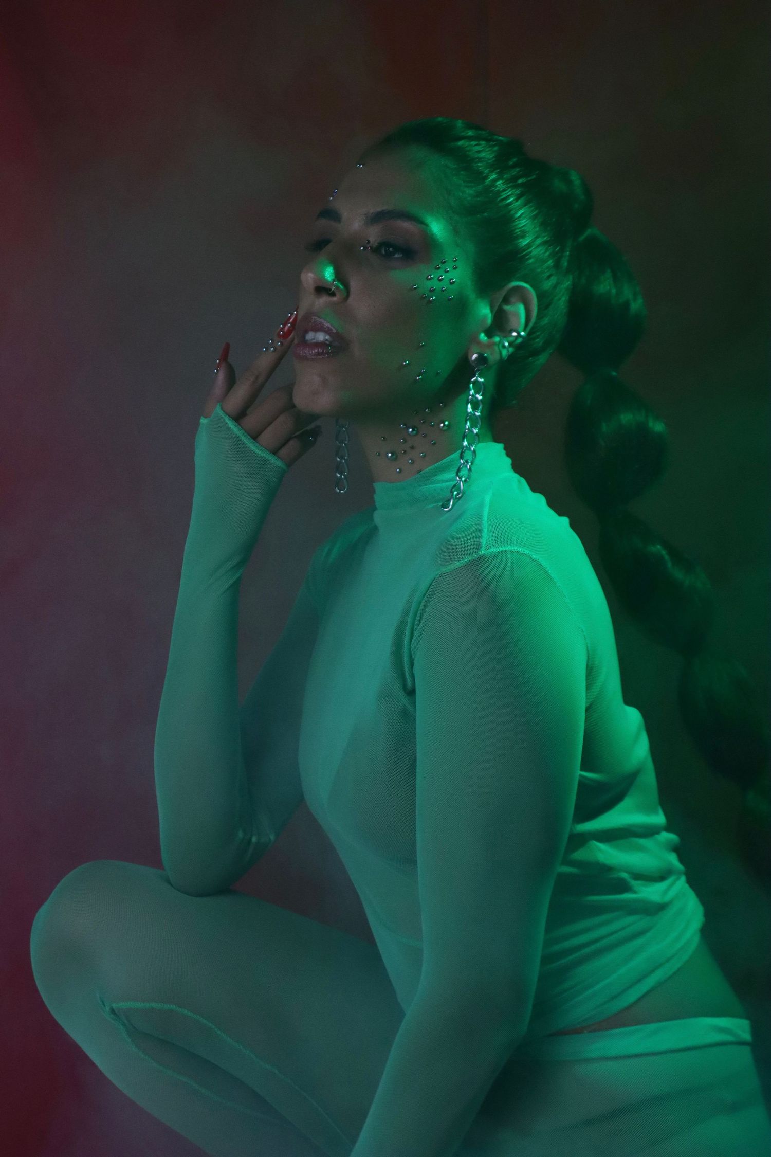 Artistic portrait bathed in green lighting creating an ethereal atmosphere.
