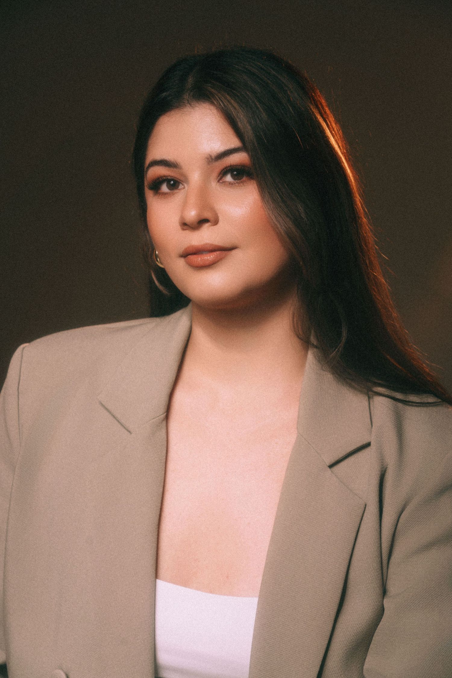 Fashion portrait series in beige blazer with dramatic side lighting effect.