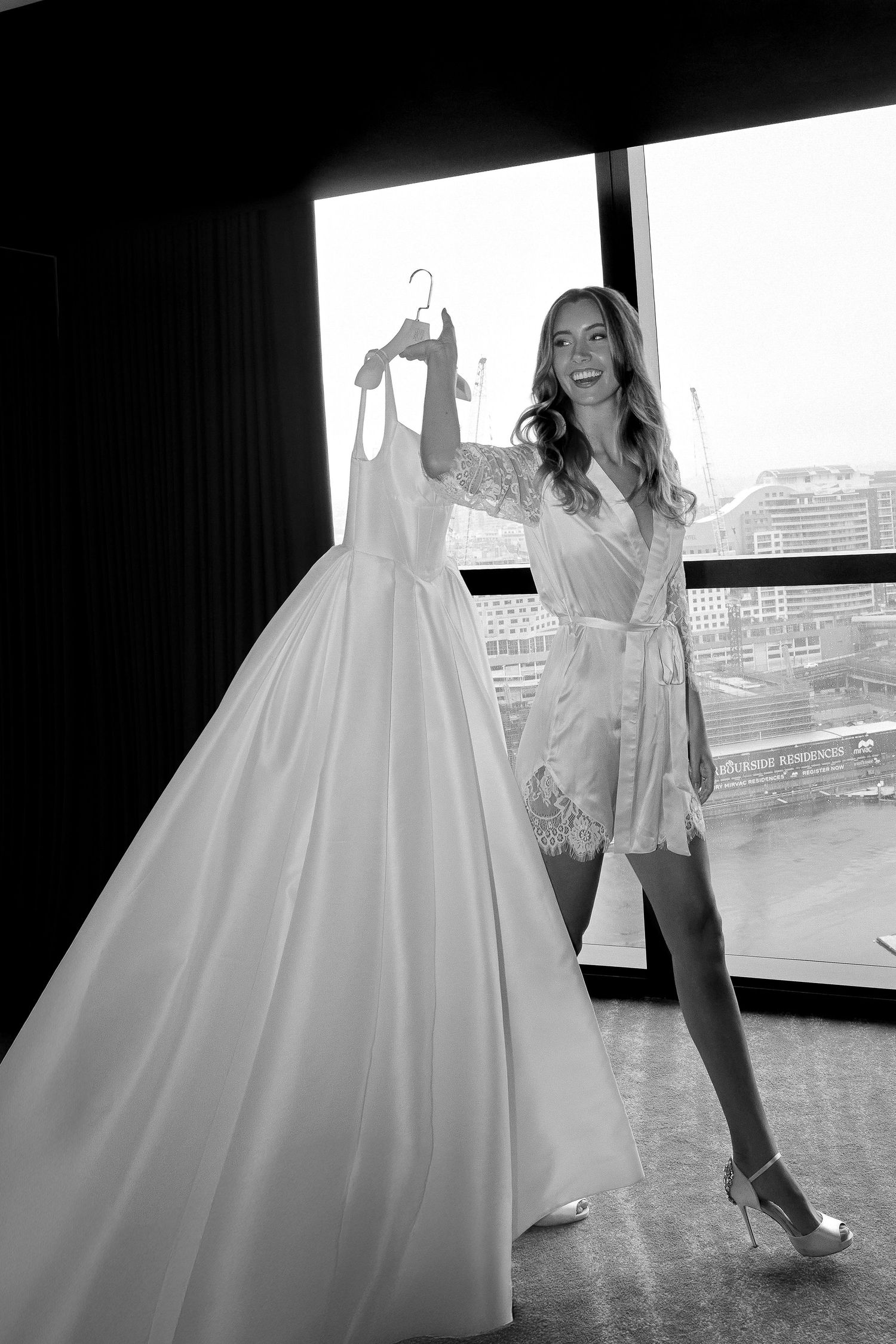 Black and white wedding photography showing dress details and candid moments.
