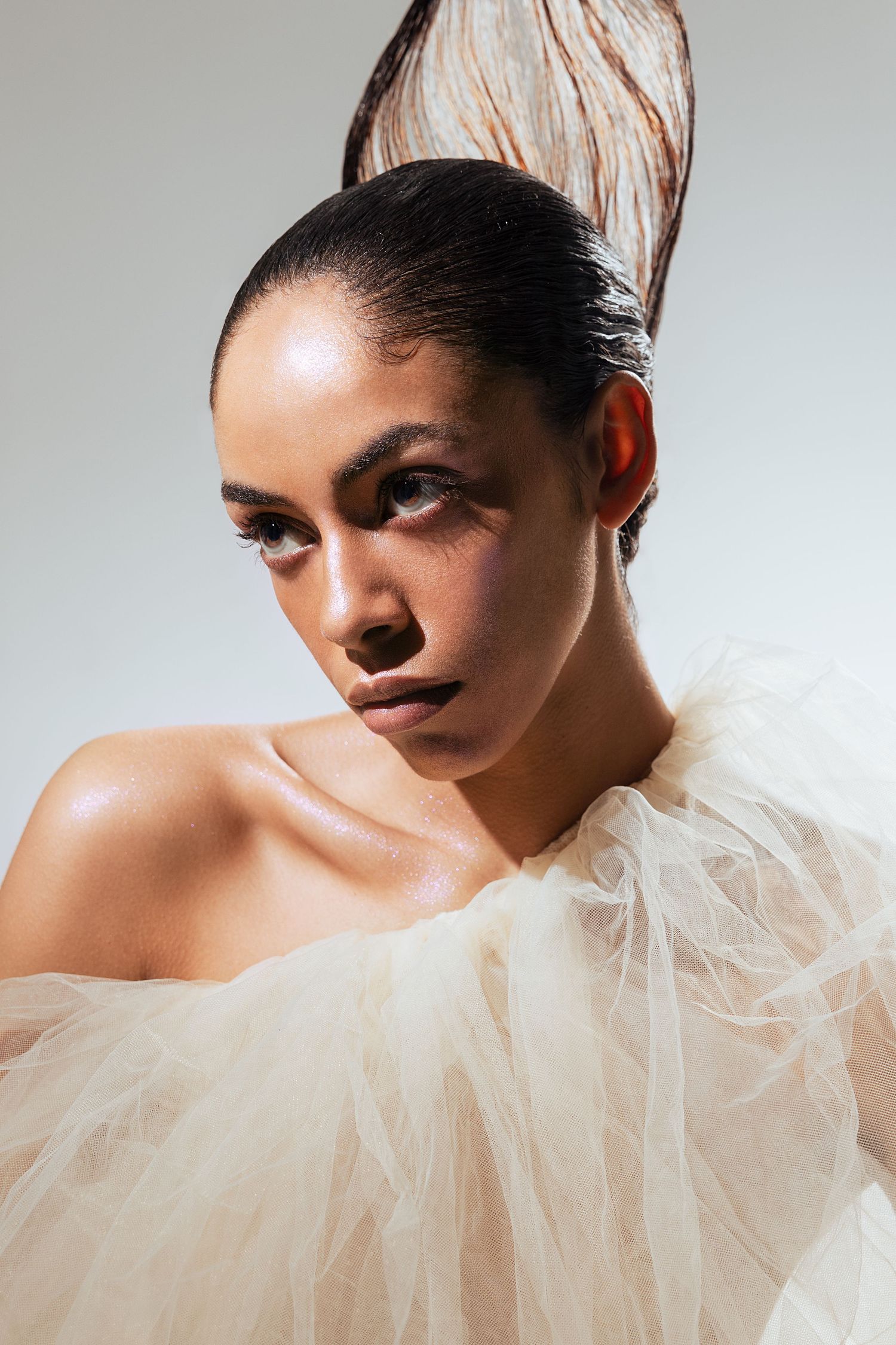 Dramatic fashion portrait series with tulle collar accessory against light gray background showing different angles and poses.