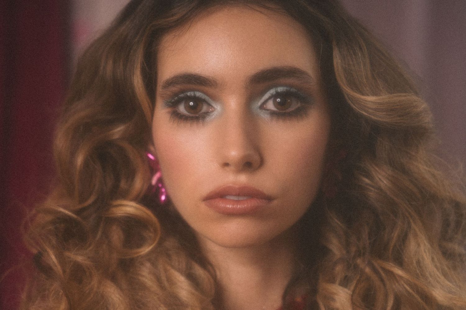 A portrait series showing different angles and expressions of someone with large eyes and wavy brown hair.