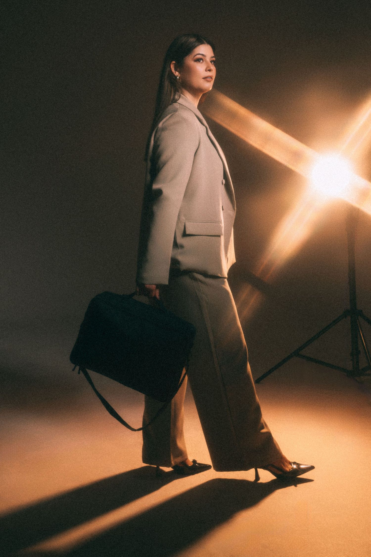 Artistic fashion shots of a person in a white blazer under dramatic lighting.
