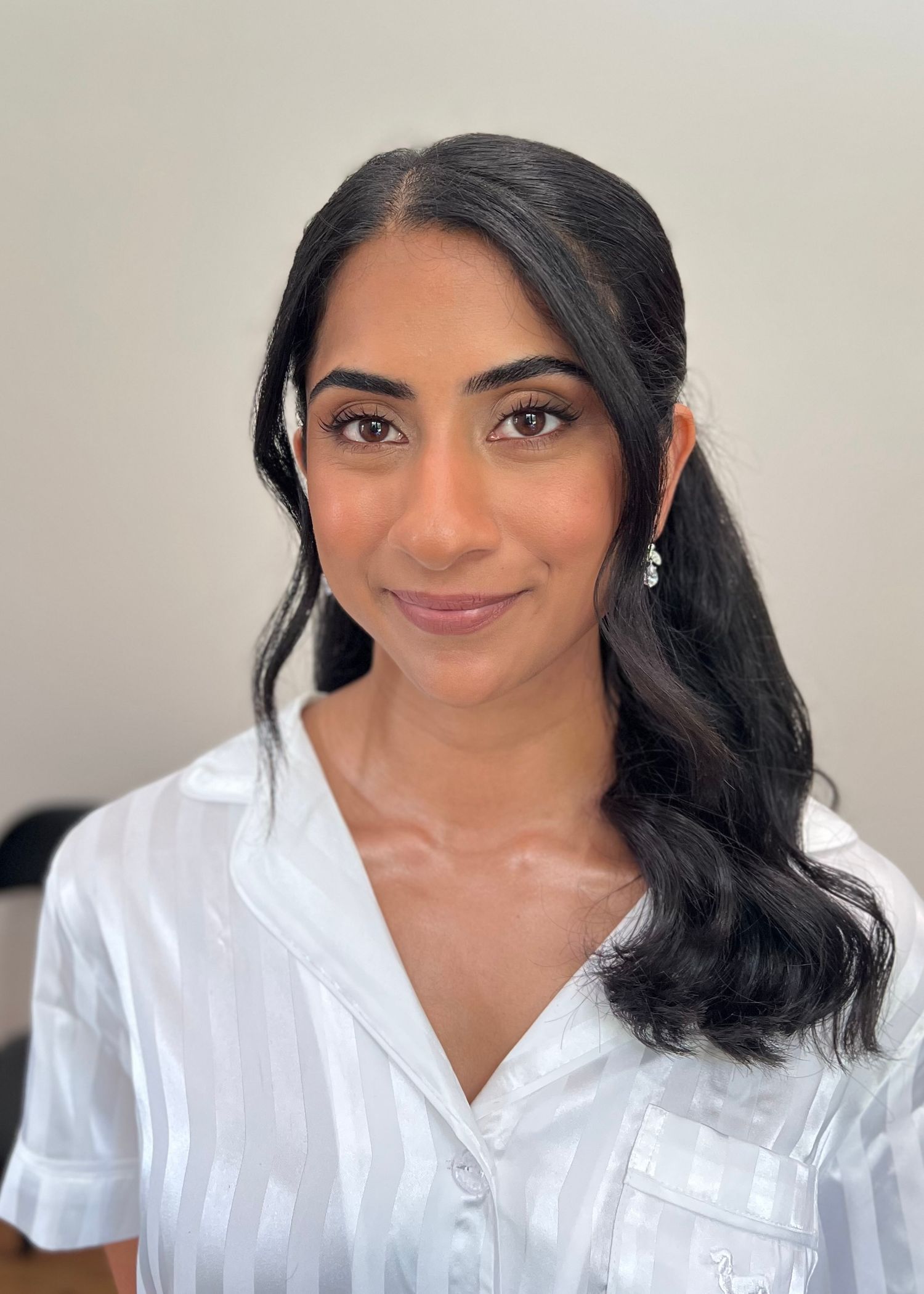 Professional headshots showing warm smile and white button-down shirt.