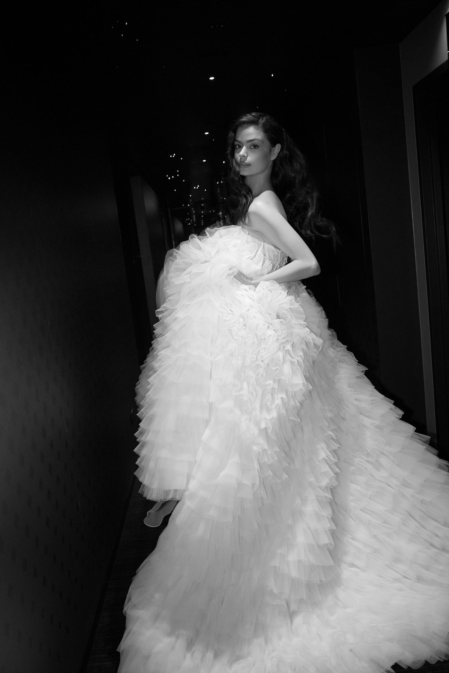 Dramatic black and white photo series featuring a voluminous white wedding gown.