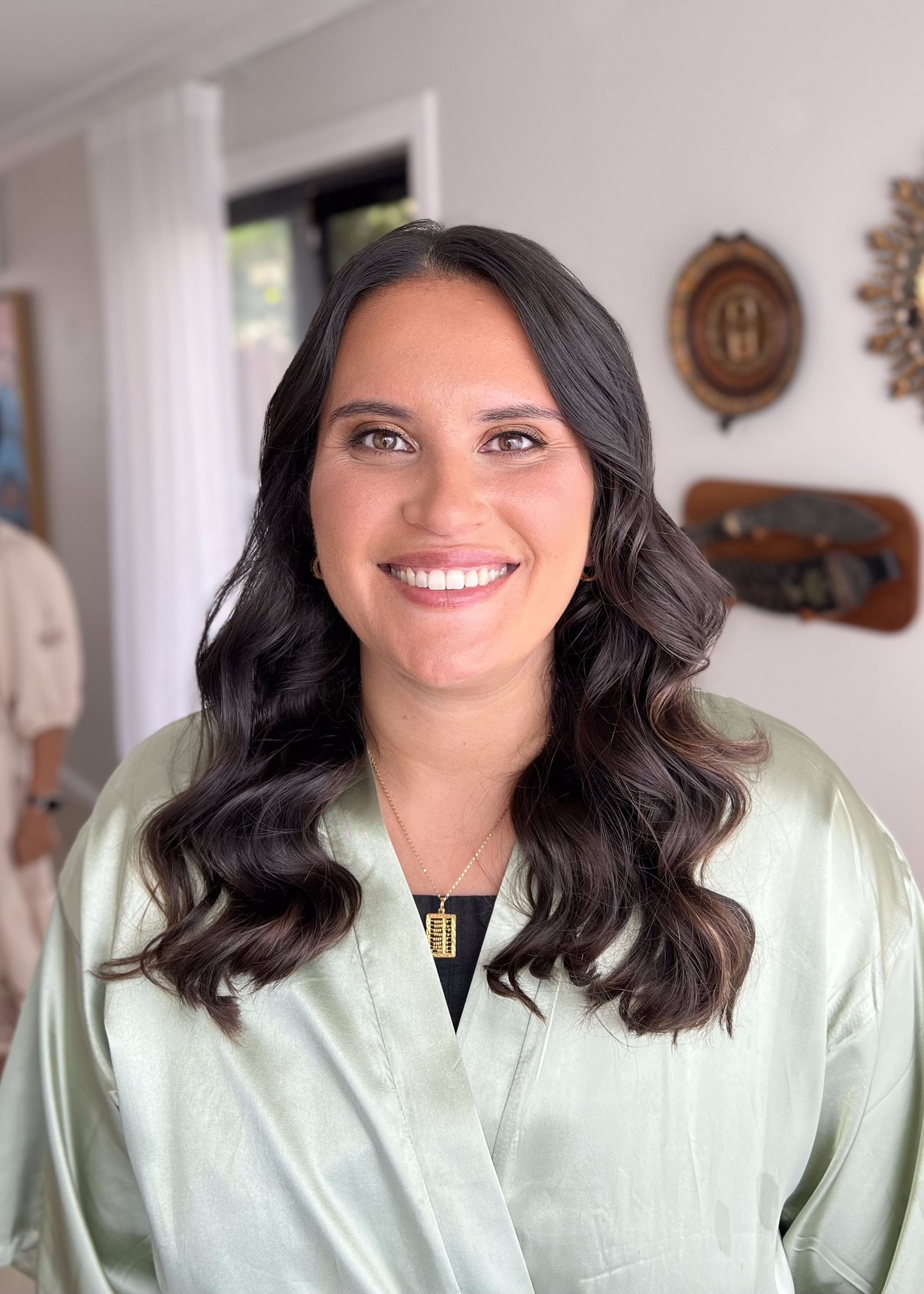 Professional portrait with dark wavy hair and mint green silk robe.
